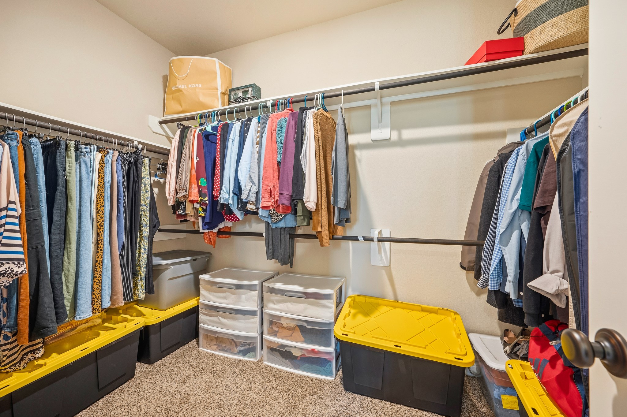 Discover a spacious walk-in closet offering ample hanging space and organized storage, keeping your wardrobe tidy and accessible.