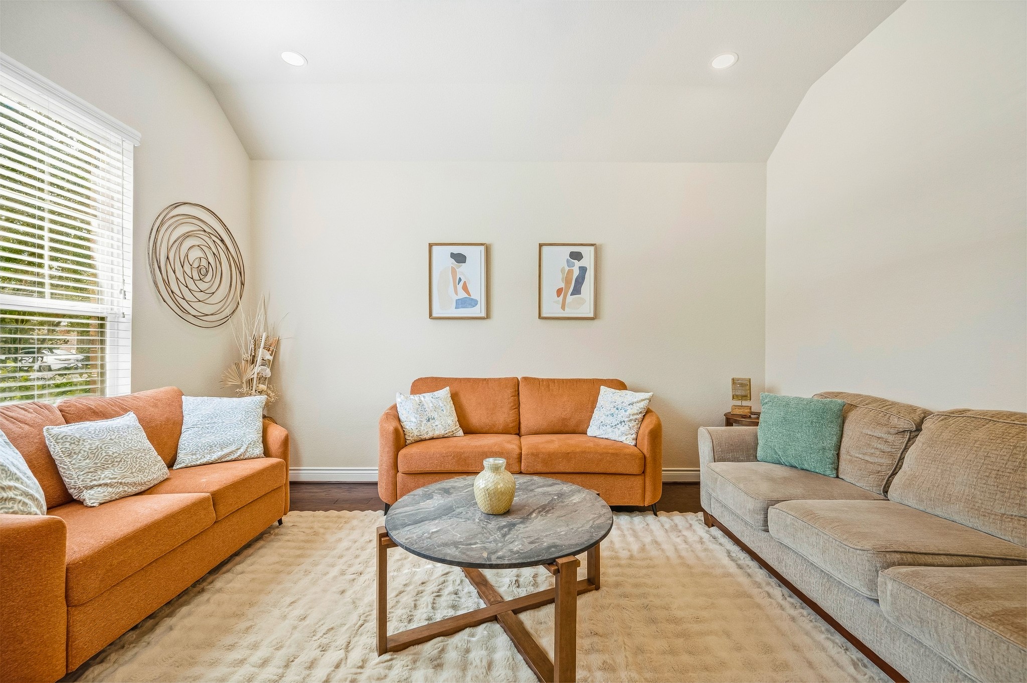 Bright and inviting, this living room boasts cozy sofas, stylish decor, and large windows that flood the space with natural light, creating the perfect setting for relaxation and entertaining.