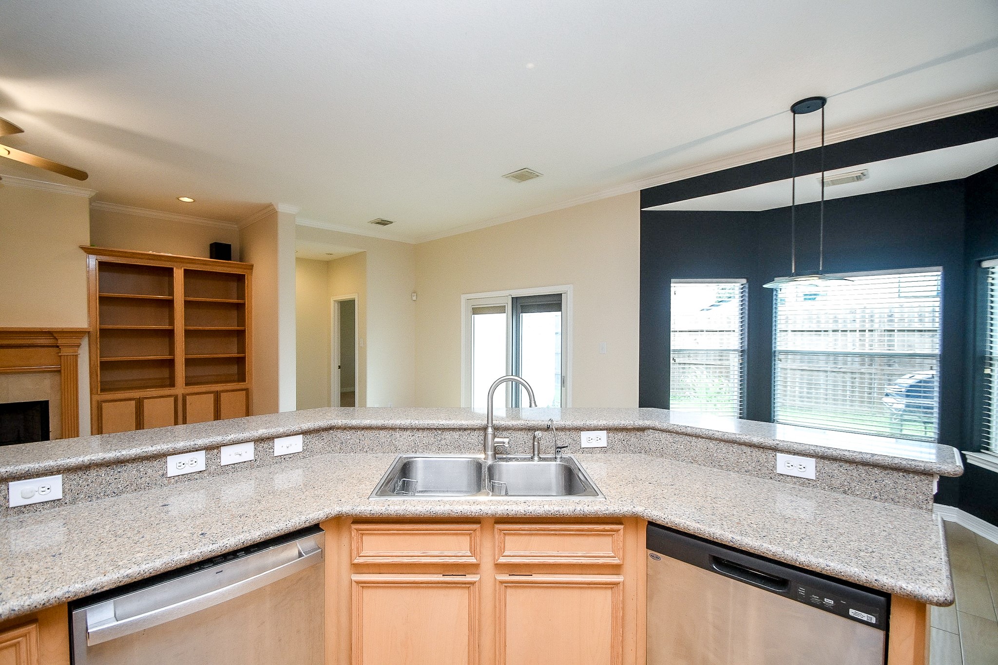 Sleek kitchen with granite countertops, stainless steel appliances, and ample natural light.