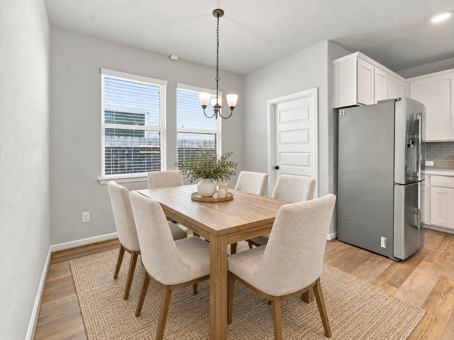 Bright dining area with windows overlooking the side yard, and convenient access to the laundry room.**Virtually staged