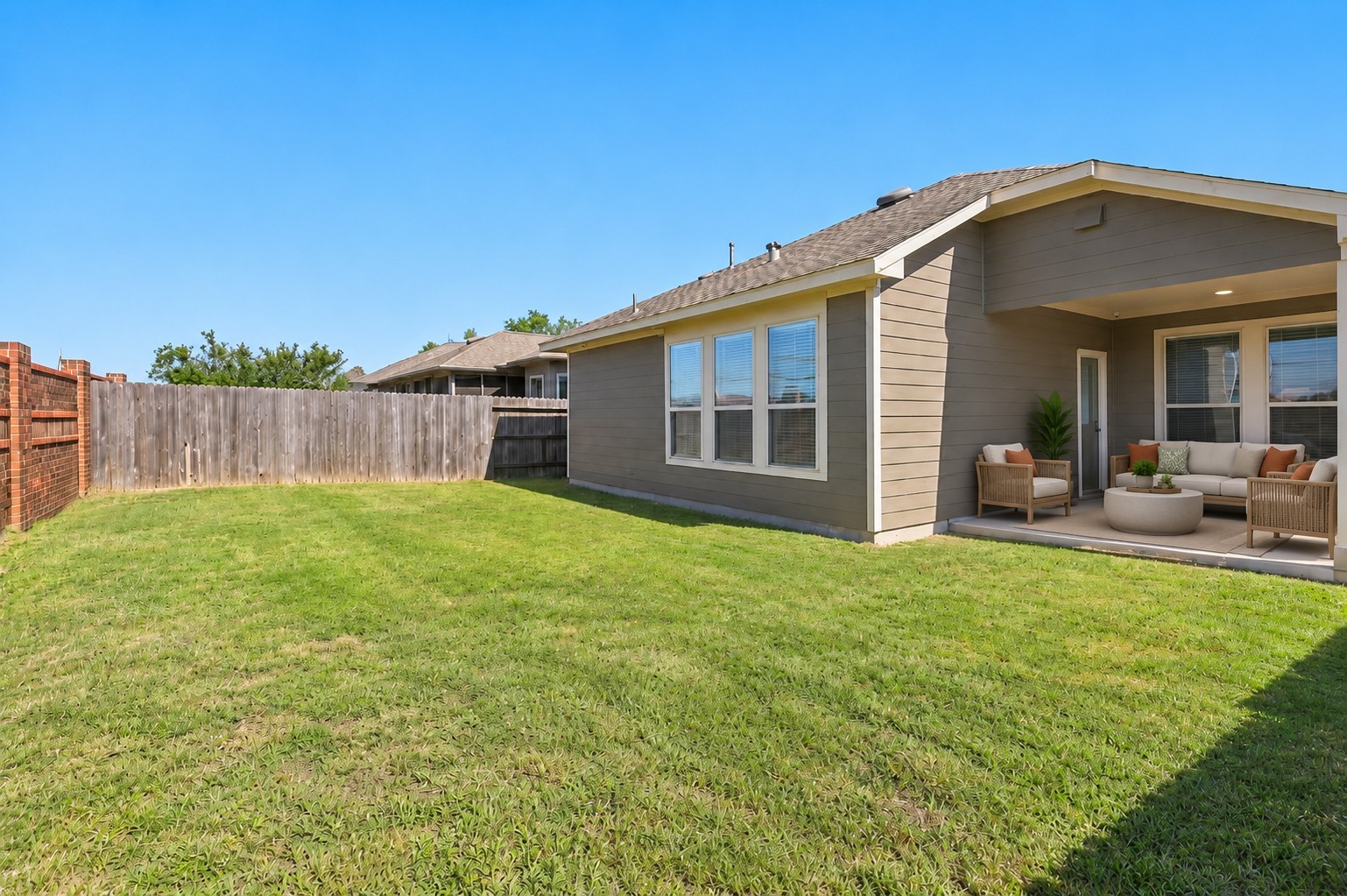 Generously sized fenced backyard offering plenty of room for outdoor recreation and future customization.