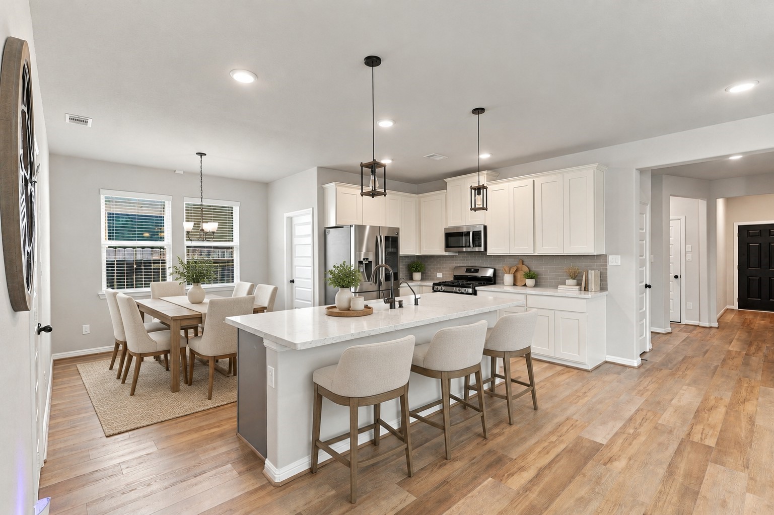 Spacious kitchen with an oversized island, stainless steel appliances, and sleek subway-tile backsplash.**Virtually staged