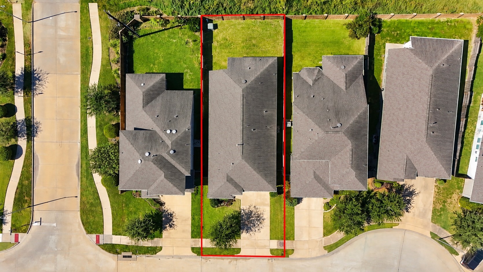 Overhead view outlines the property's lot, single-story footprint, driveway, and fenced backyard.