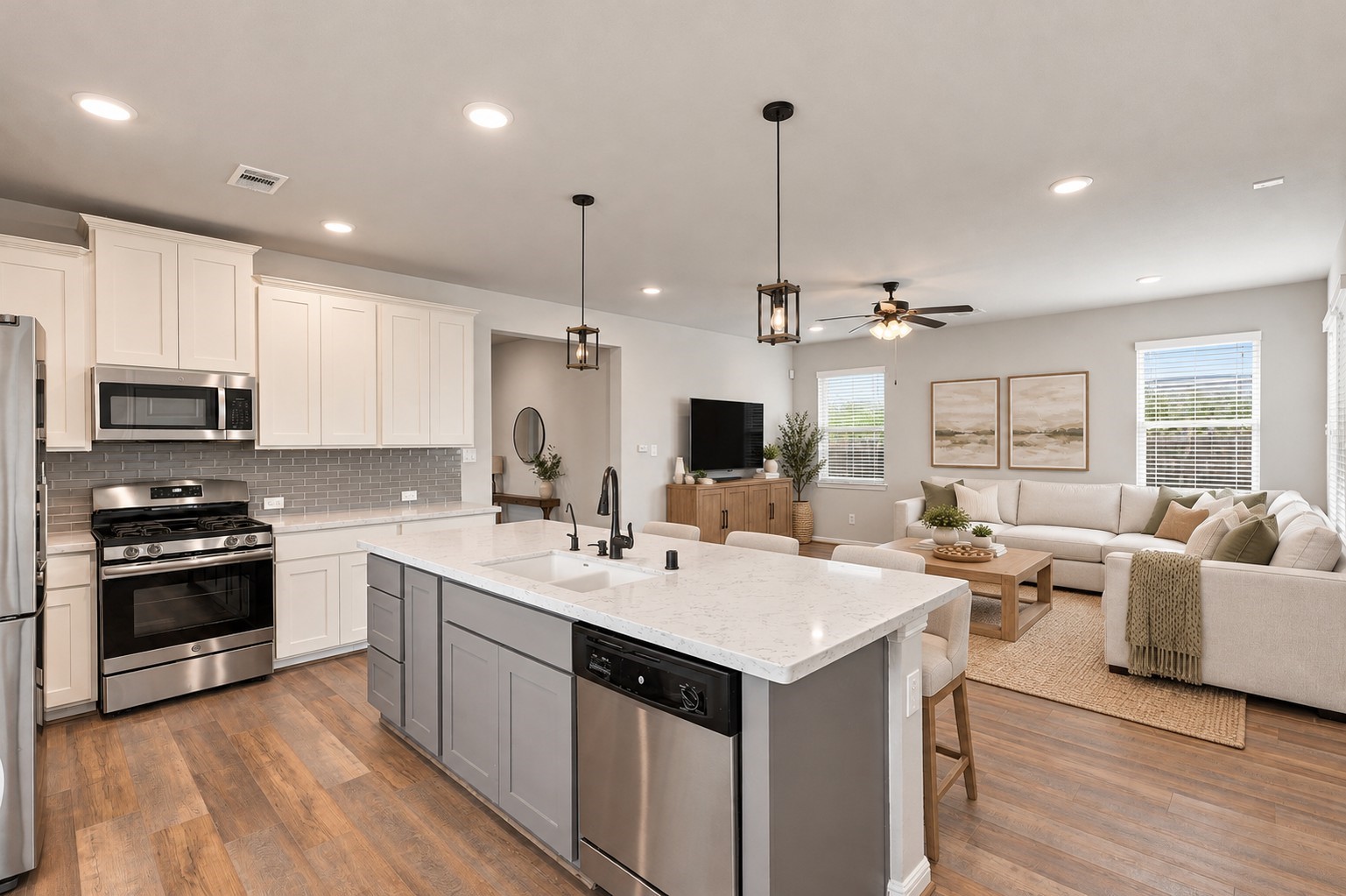 Open-concept design connects the kitchen to a bright family room with abundant natural light..**Virtually staged