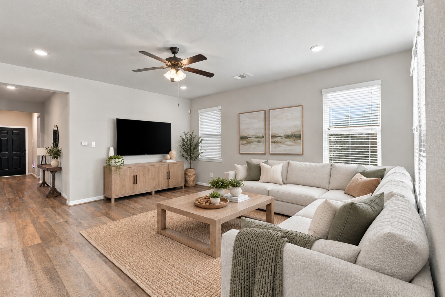 Spacious family room with a clear view of the entry hallway and easy access to the home's adjoining spaces.**Virtually staged