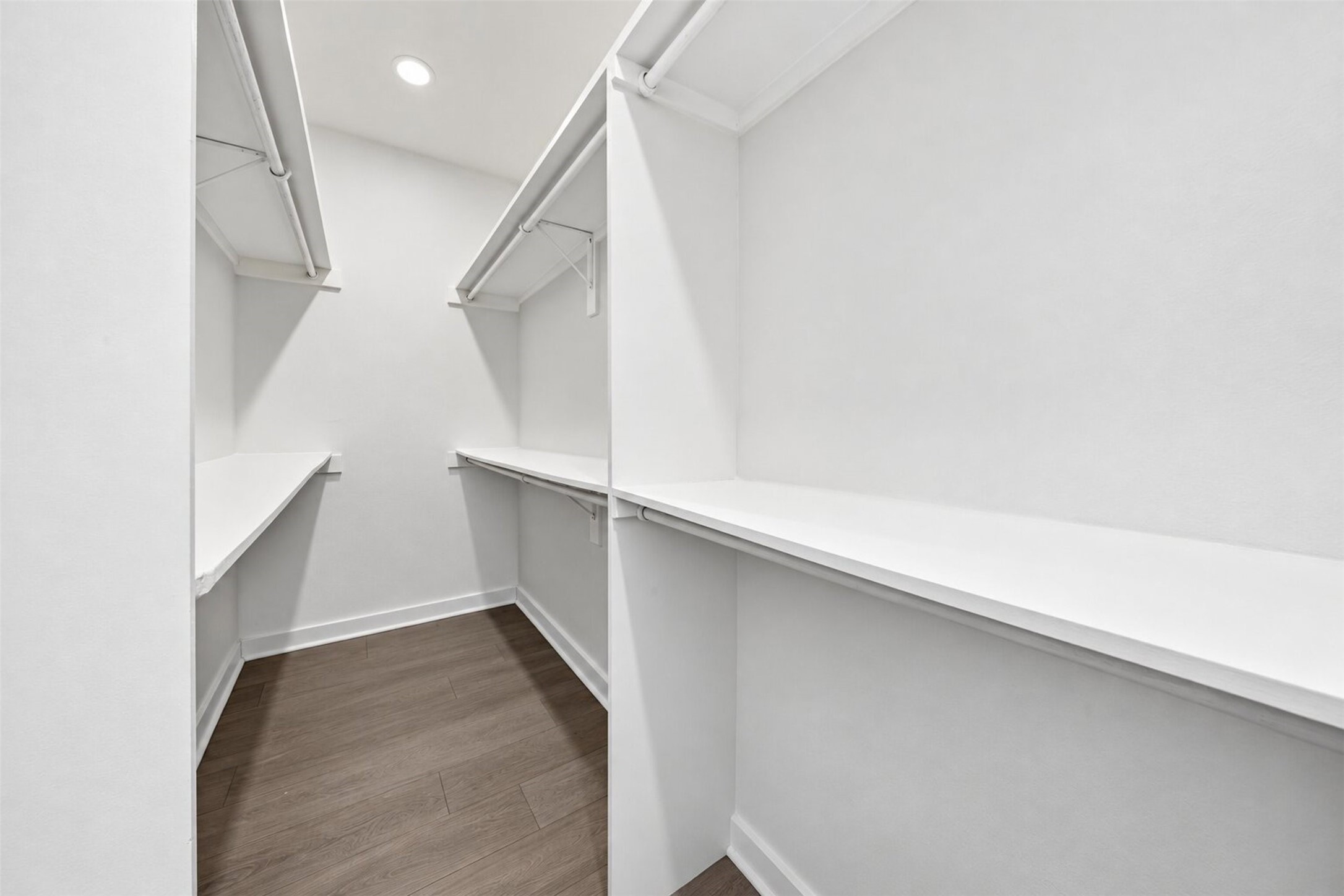 Spacious walk-in closet featuring plenty of shelving and storage options.