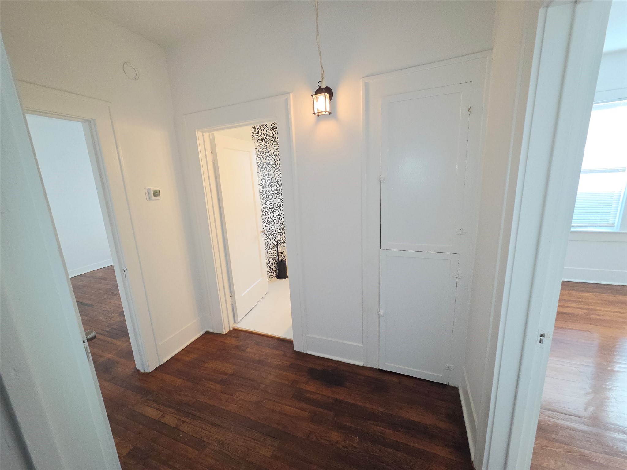 hallway with entrance to guest bath and both guest bedrooms