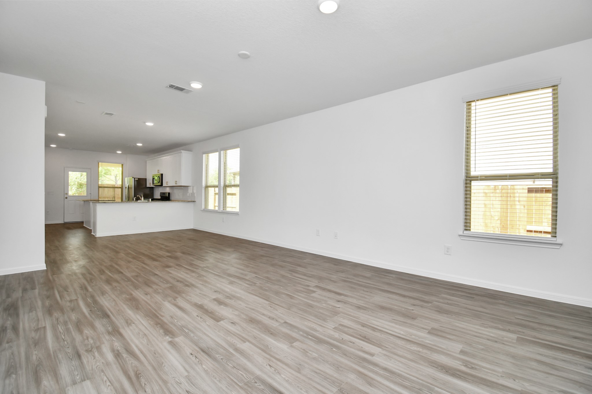 Upon stepping inside, you're immediately greeted by an abundance of natural light that bathes the open-concept living space. The interior design is a perfect blend of modern sophistication and warm, inviting elements. High ceilings and large windows create an airy and spacious atmosphere, while gleaming wood style floors flow throughout common areas, adding a touch of luxury. Upon stepping inside, you're immediately greeted by an abundance of natural light that bathes the open-concept living space. The interior design is a perfect blend of modern sophistication and warm, inviting elements. High ceilings and large windows create an airy and spacious atmosphere, while gleaming wood style floors flow throughout common areas, adding a touch of luxury.