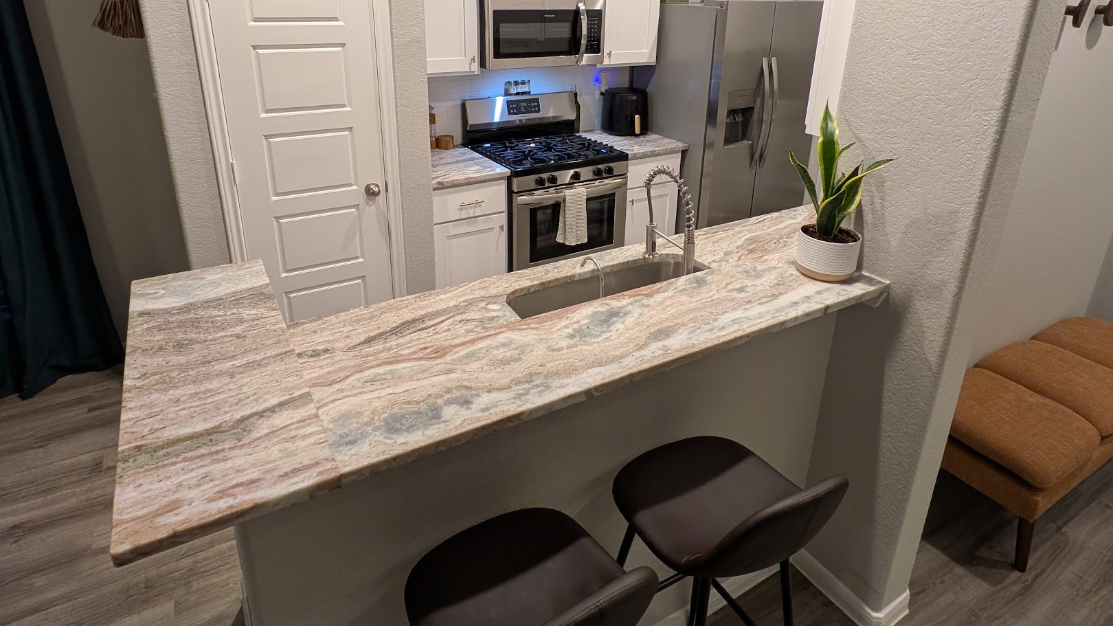 You will love this extended Breakfast Bar with gorgeous granite kitchen countertops, and lots of room for seating. The space is bright with recessed lighting creating a welcoming atmosphere.