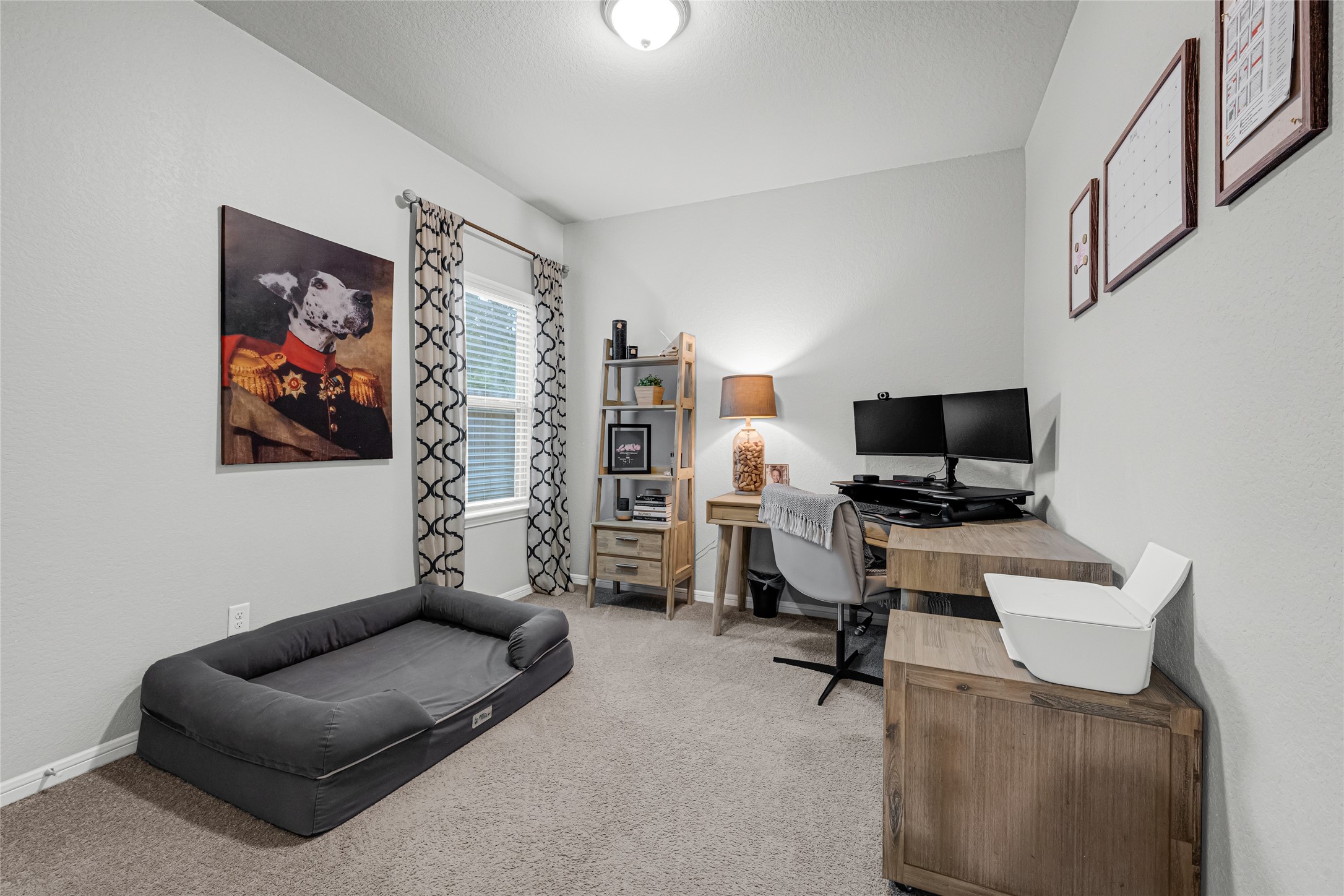 This cozy home office/bedroom features neutral walls, Mohawk carpeting over 3/8 inch padding will be found in all carpeted areas, and ample natural light from a window with stylish curtains. Making this space flexible an ideal space for both work and relaxation, playroom or a bedroom....whatever fits your needs.