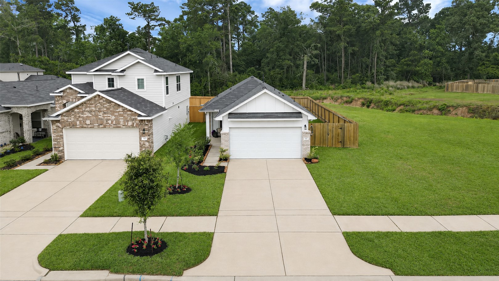 This fabulous single-story home features an extra long double sided driveway offering plenty of parking space. The neighborhood is lined with trees and sidewalks, providing a serene backdrop.