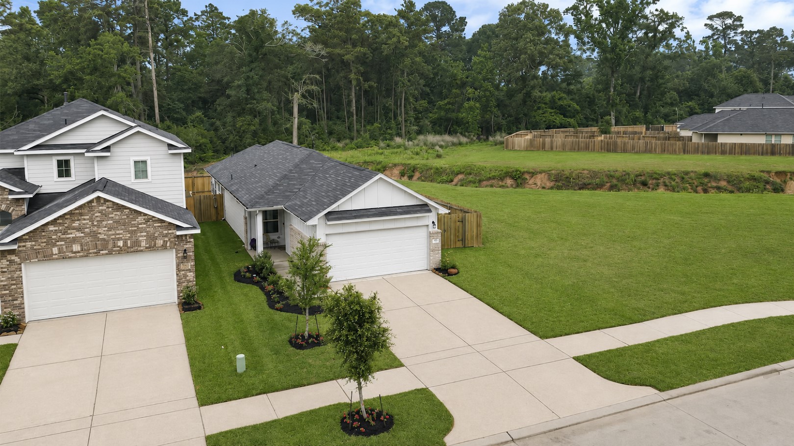 Charming single-story home has gutters installed in the front and a wooded backdrop, providing a peaceful setting.