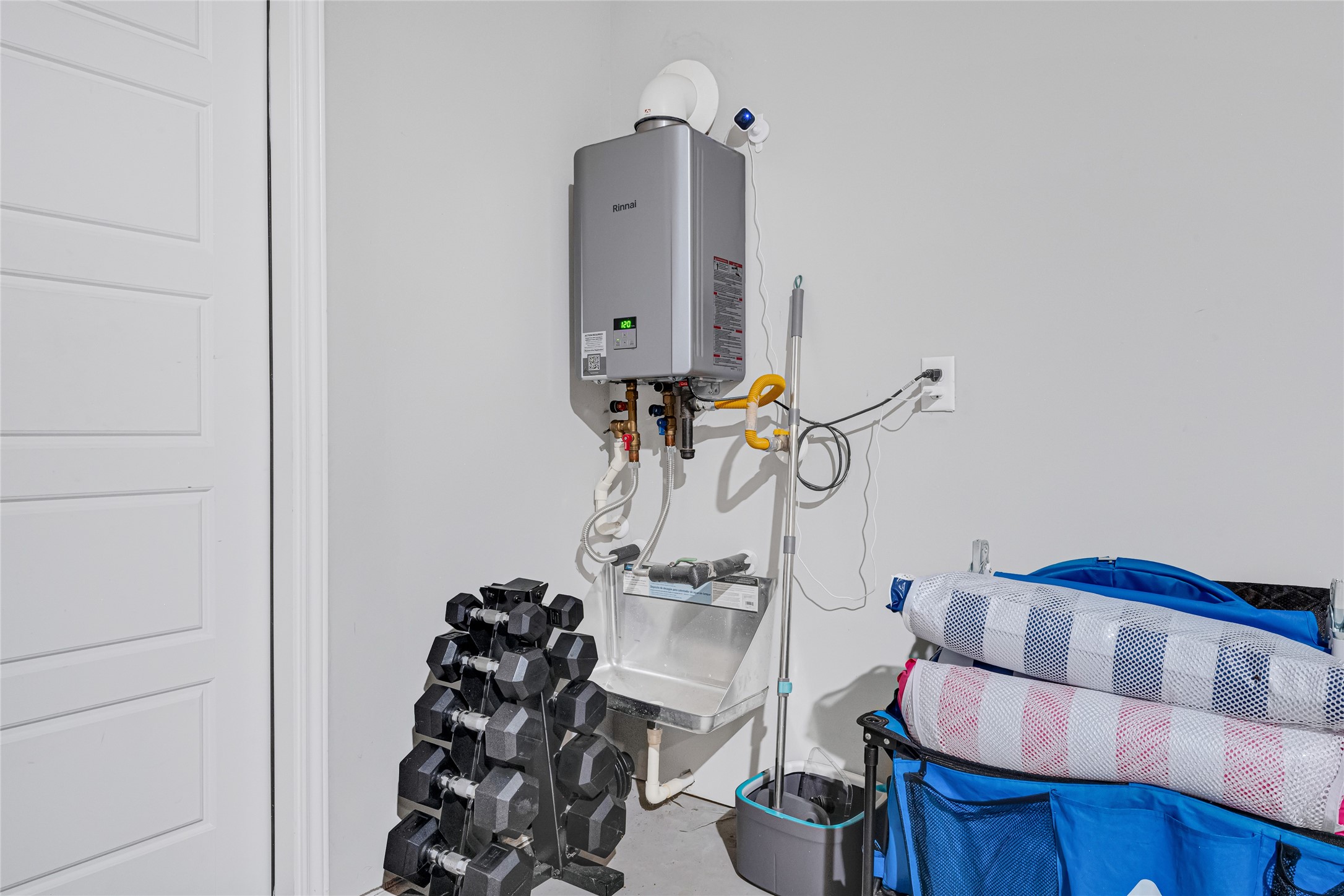 The garage houses the sleek tankless water heater, this home has a PEX water distribution system.