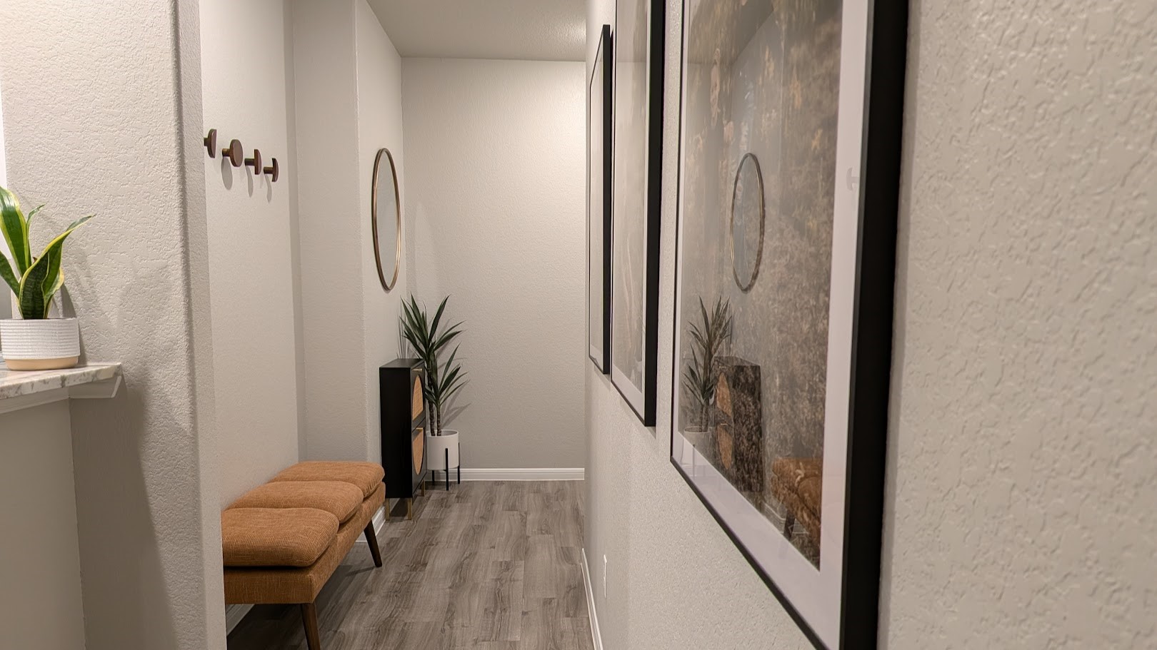 A practical little nook just off the entryway keeps bags, coats, and backpacks out of the main living space  the kind of thoughtful detail that makes daily life easier.