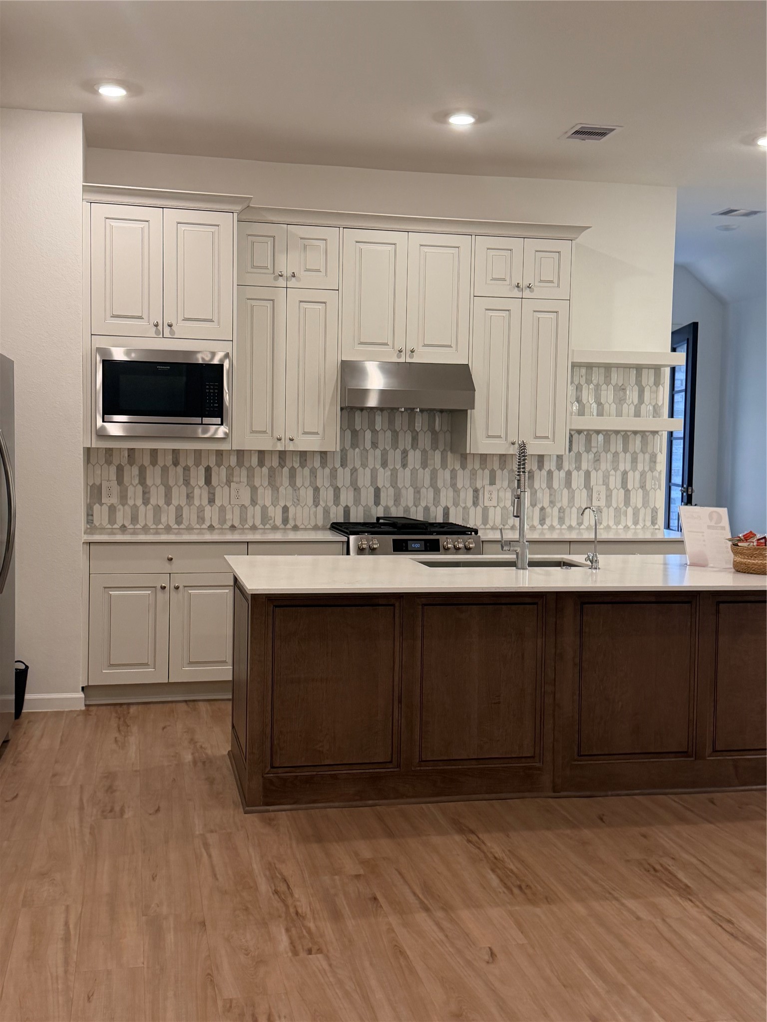 Kitchen with quartz countertops and custom tile on back splash