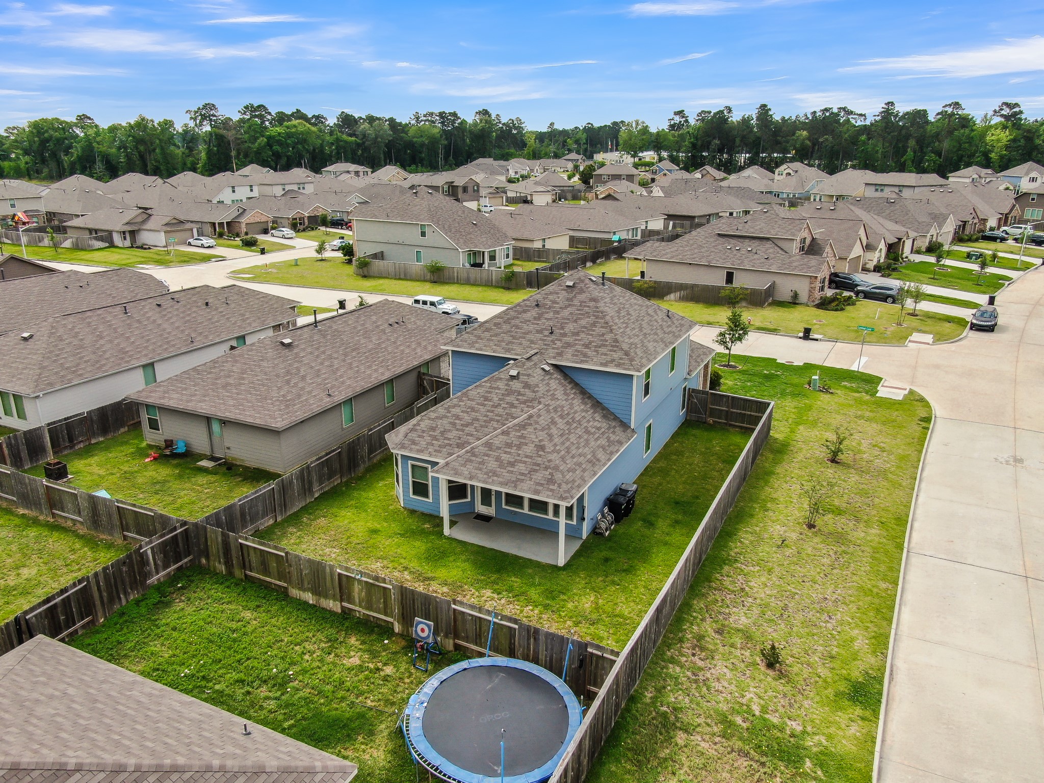 Charming two-story home with a spacious fenced backyard, perfect for families. The neighborhood features well-maintained homes and lush green surroundings, offering a tranquil suburban feel.