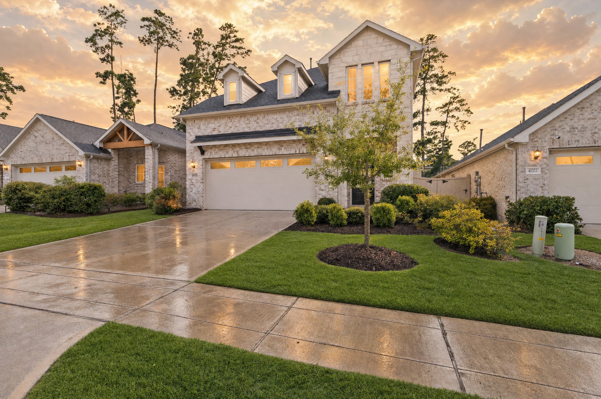 Coming home feels welcoming from the curb, with a neatly landscaped front yard, attached garage, and inviting entry. This photo has been digitally edited.