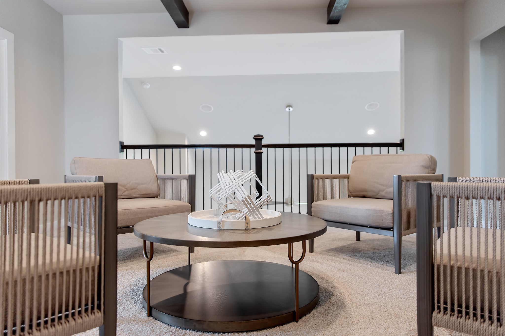 Come upstairs and relish a day of relaxation in this loft area! Ideal as an additional living space or game room, it boasts plush carpeting, high ceilings, custom paint, and windows that flood the area with abundant natural light.