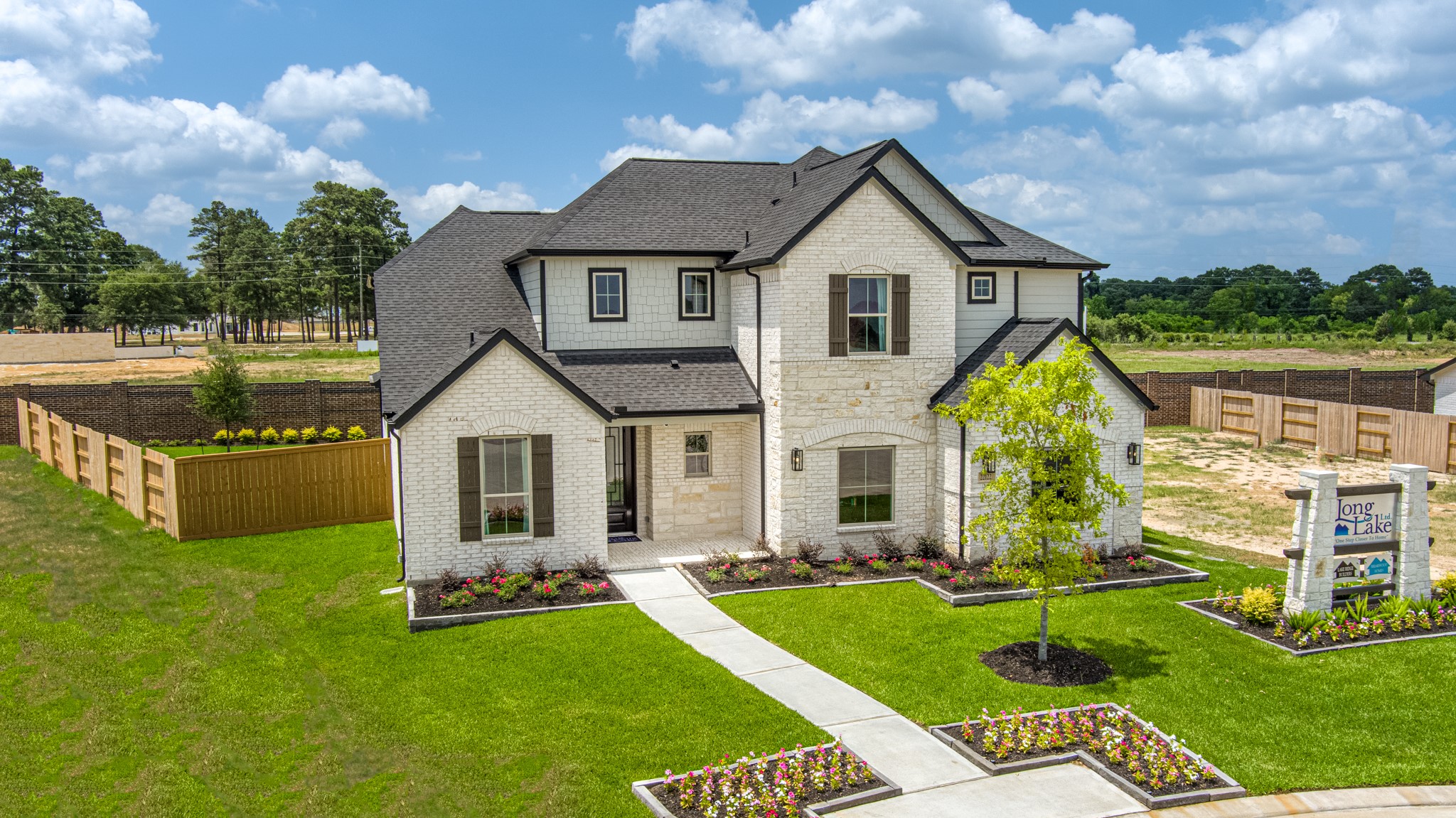 Meticulously maintained yard and lush landscape, paired with a premium elevation featuring captivating brick accents. Modern coach lights add a touch of contemporary elegance to the exterior.