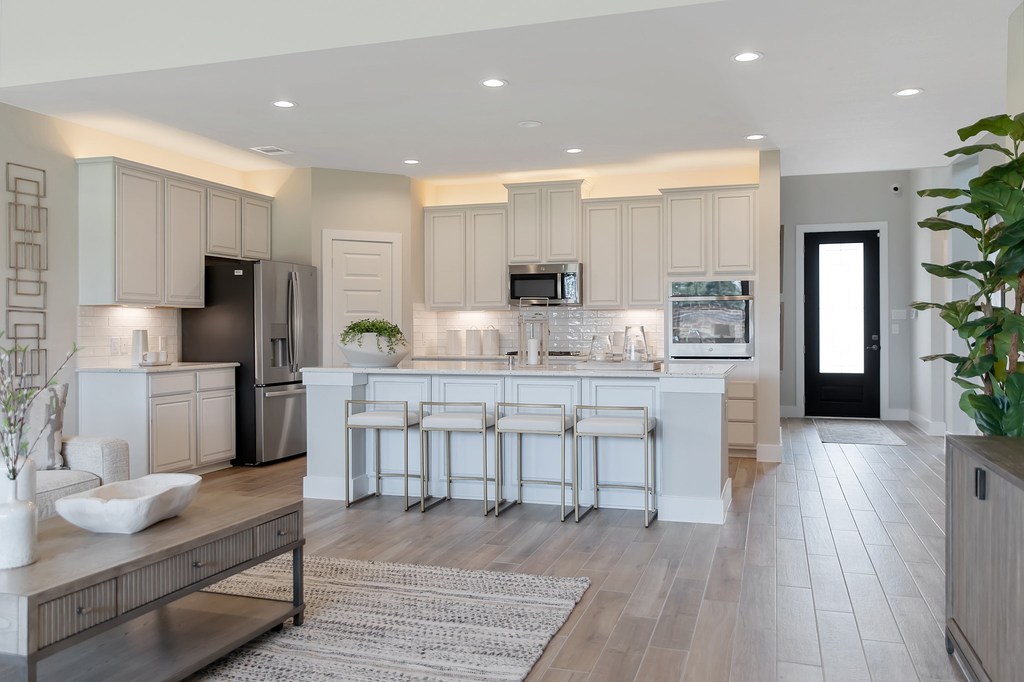 The kitchen is a culinary haven, featuring granite countertops, a tile backsplash, stainless steel appliances, 42 upper cabinets, and undercabinet lighting.