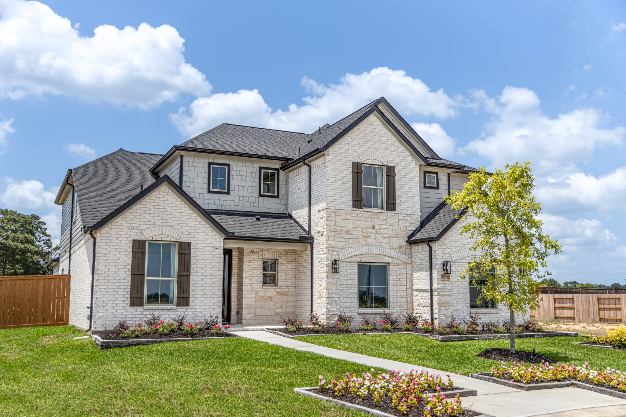 The residence features a practical 2-car garage complemented by a generous driveway, ensuring abundant space for parking needs.