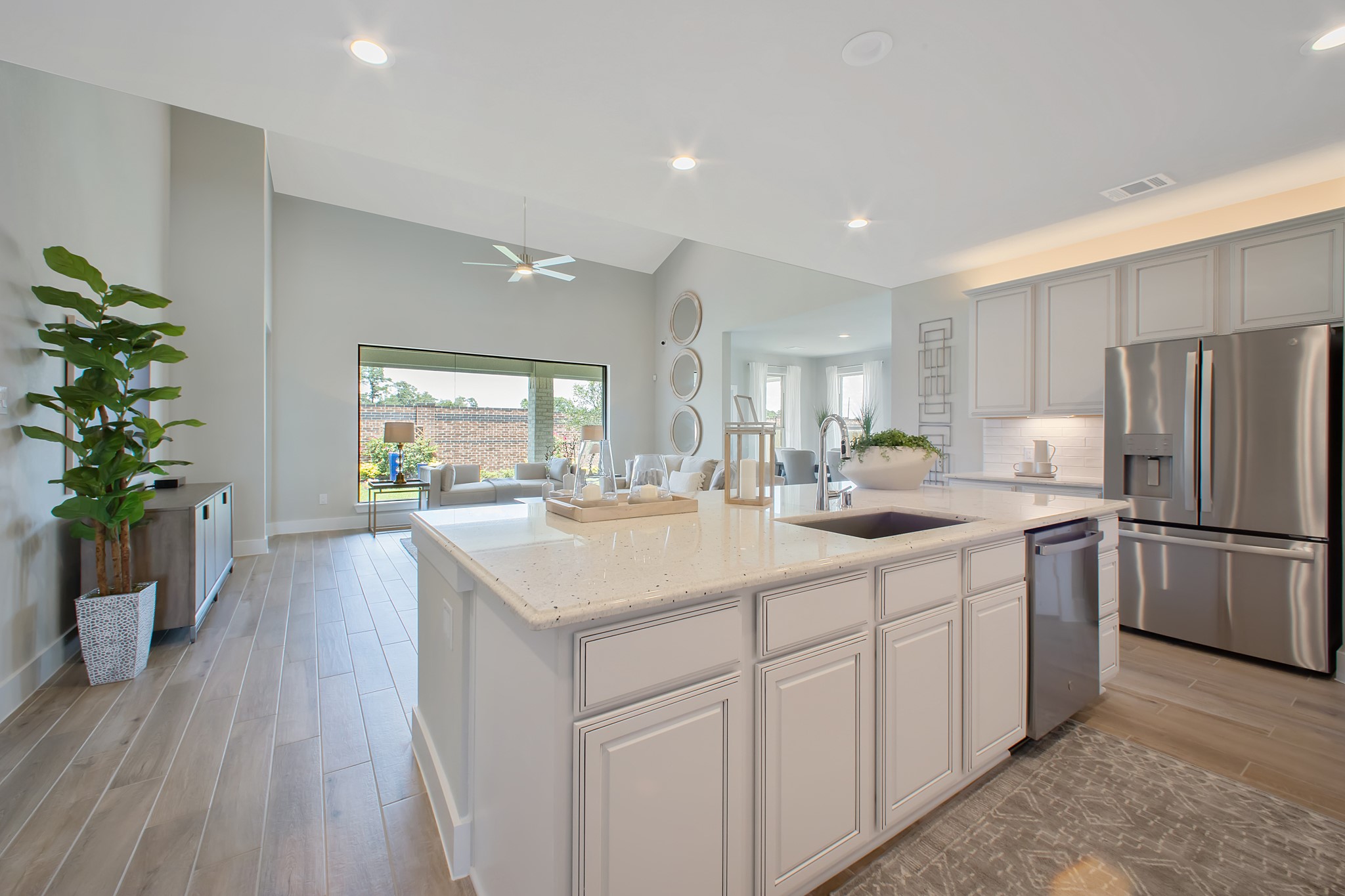 This generously spacious kitchen is a dream realized! With a massive granite island, high ceilings, soft close cabinets, granite countertops, stainless steel appliances, a sleek tile backsplash, recessed lighting, and an extended counter area, it offers both style and practicality. All this opens up to the expansive family room, creating a perfect hub for gatherings.