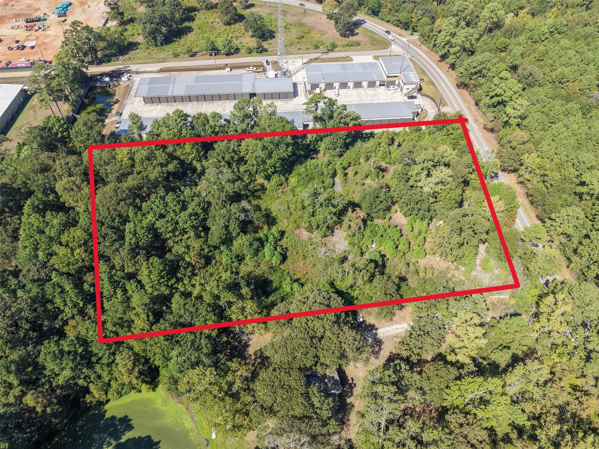 Aerial view highlighting the wooded property boundaries and road frontage. This tract offers an attractive setting with convenient access near Lake Conroe. Aerial view highlighting the wooded property boundaries and road frontage. This tract offers an attractive setting with convenient access near Lake Conroe.