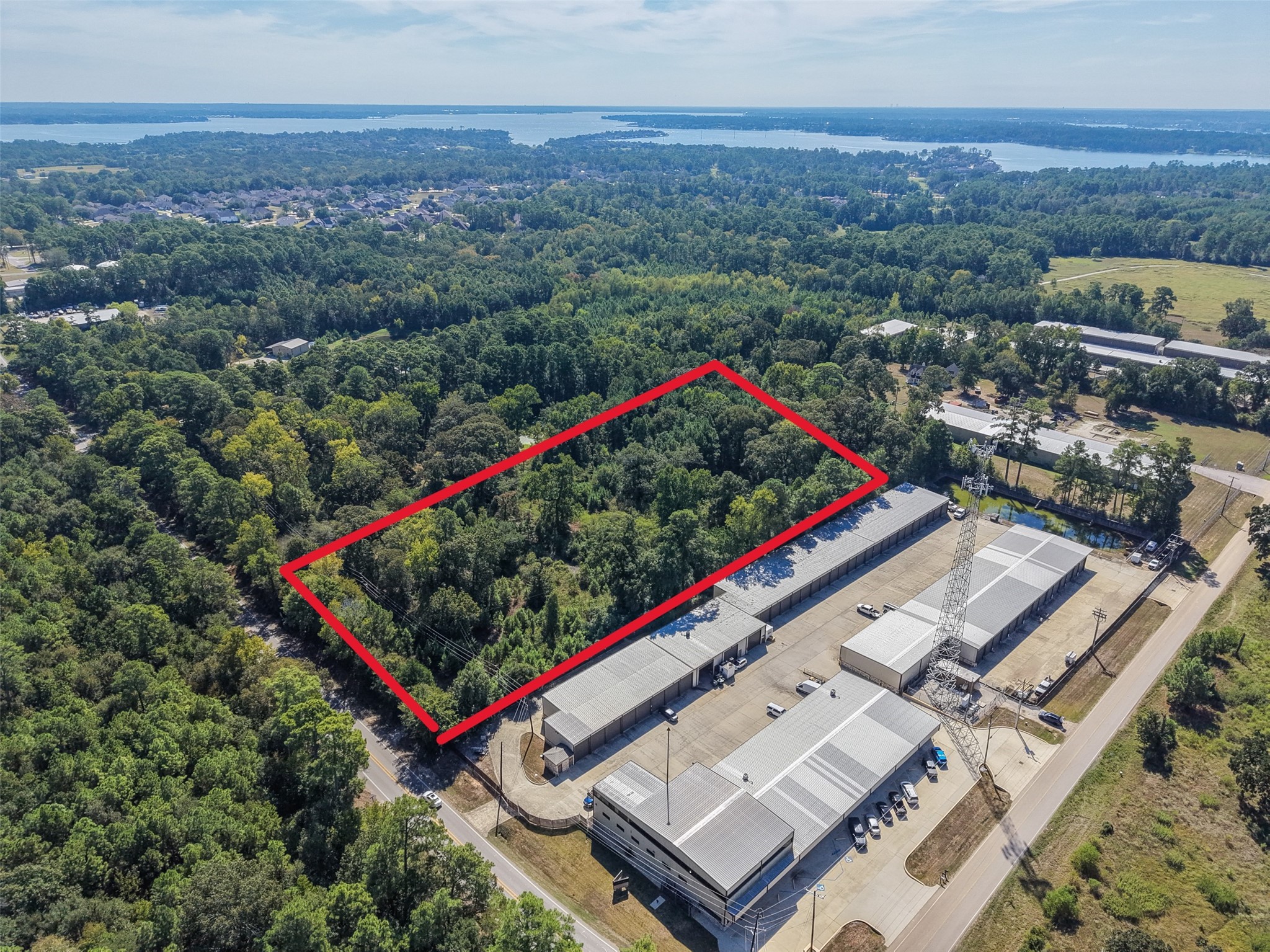 Stunning aerial perspective of the property surrounded by lush greenery, with beautiful Lake Conroe visible in the distance. Enjoy the combination of a wooded setting and convenient access to surrounding amenities. Stunning aerial perspective of the property surrounded by lush greenery, with beautiful Lake Conroe visible in the distance. Enjoy the combination of a wooded setting and convenient access to surrounding amenities.