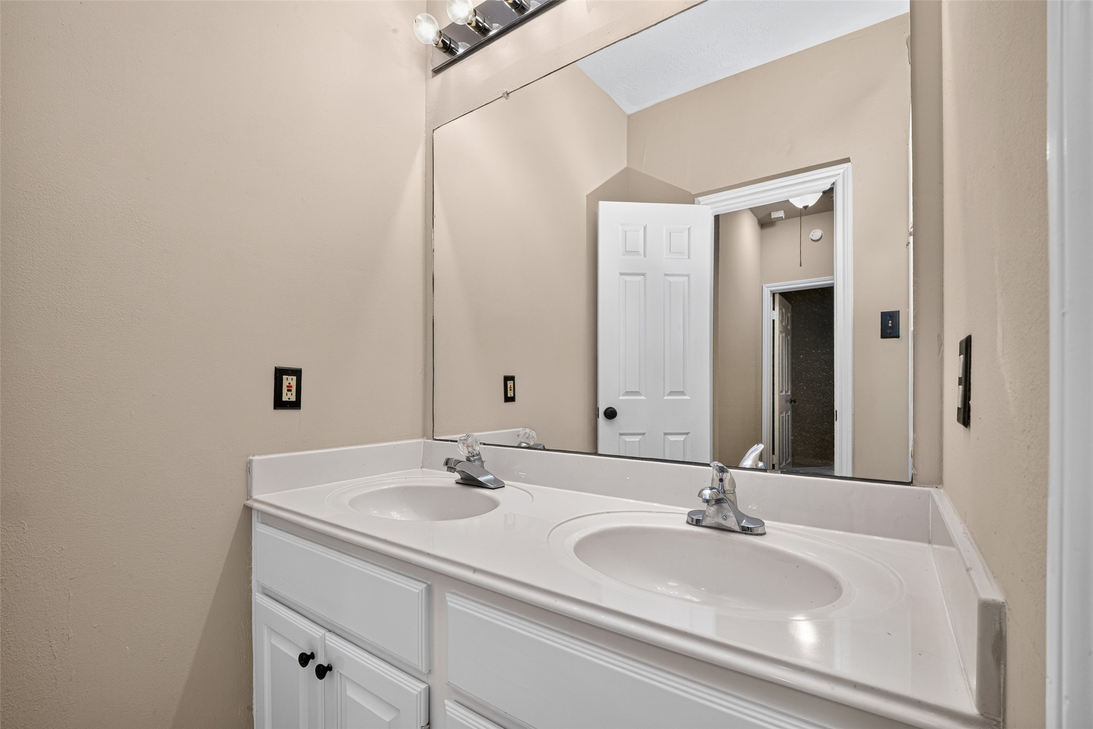 Secondary bath with double sinks.