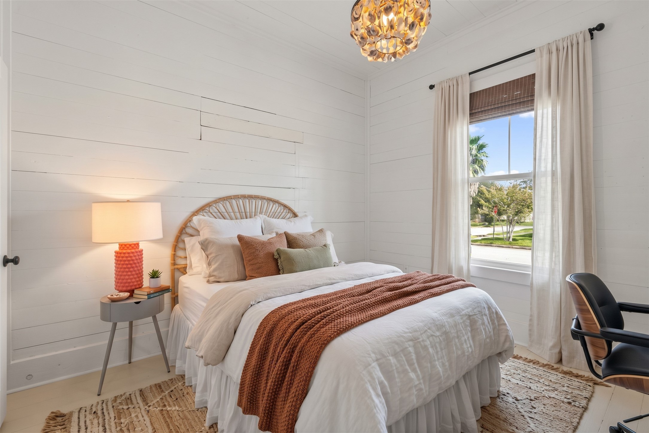 Bright bedroom with natural light and soft neutral finishes.