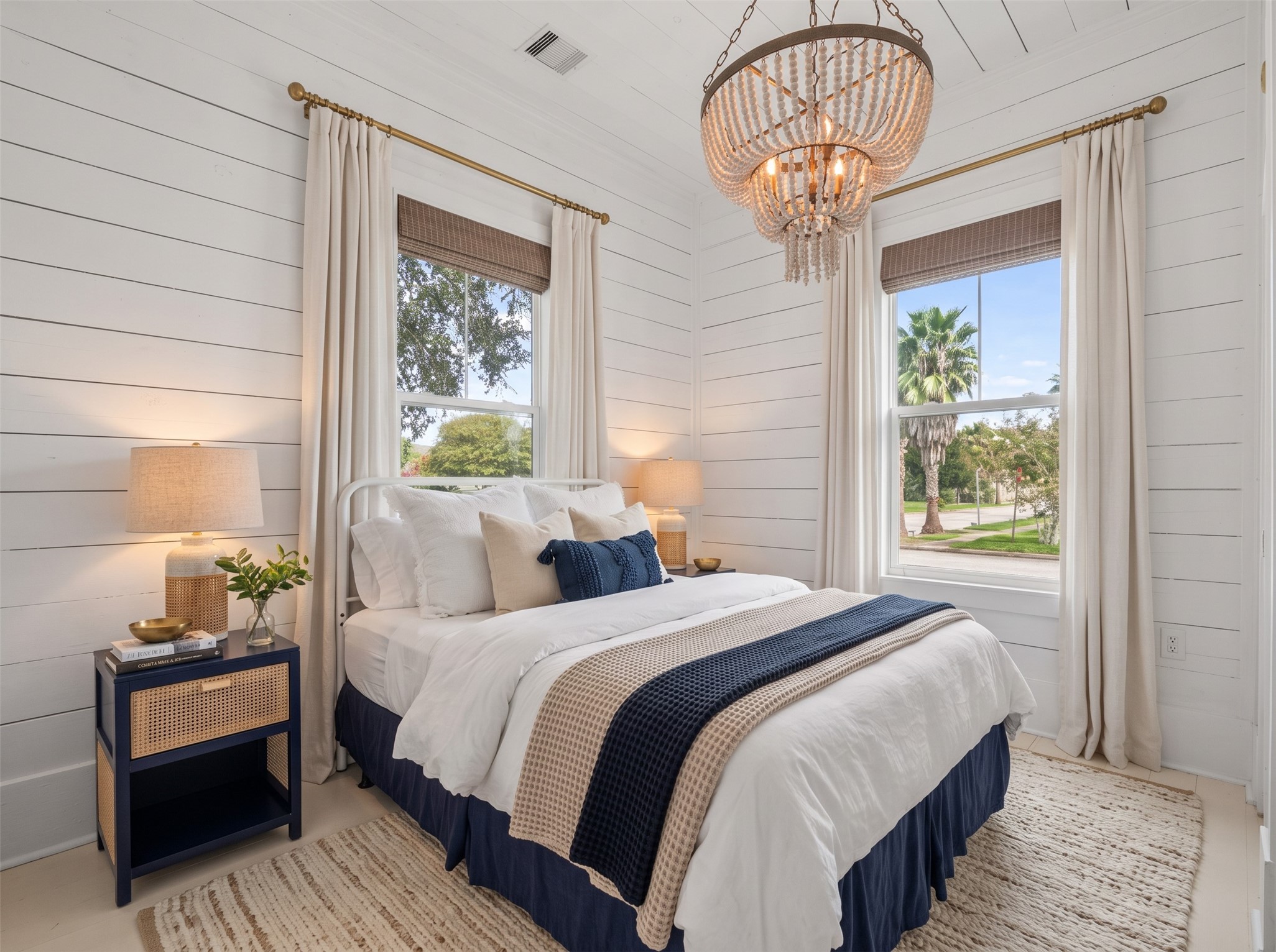 Another view of the bedroom highlighting the windows and layout.