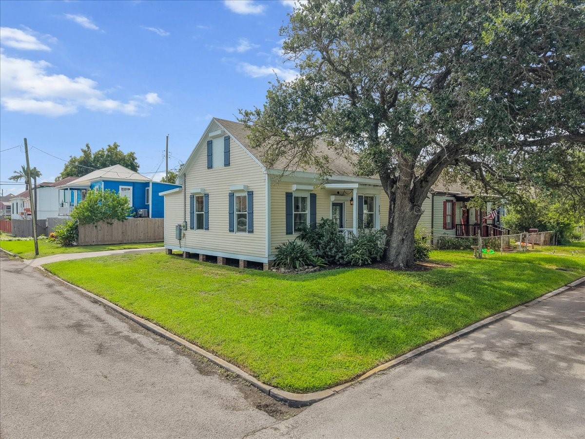 Wide front view showcasing the home and surrounding lot.