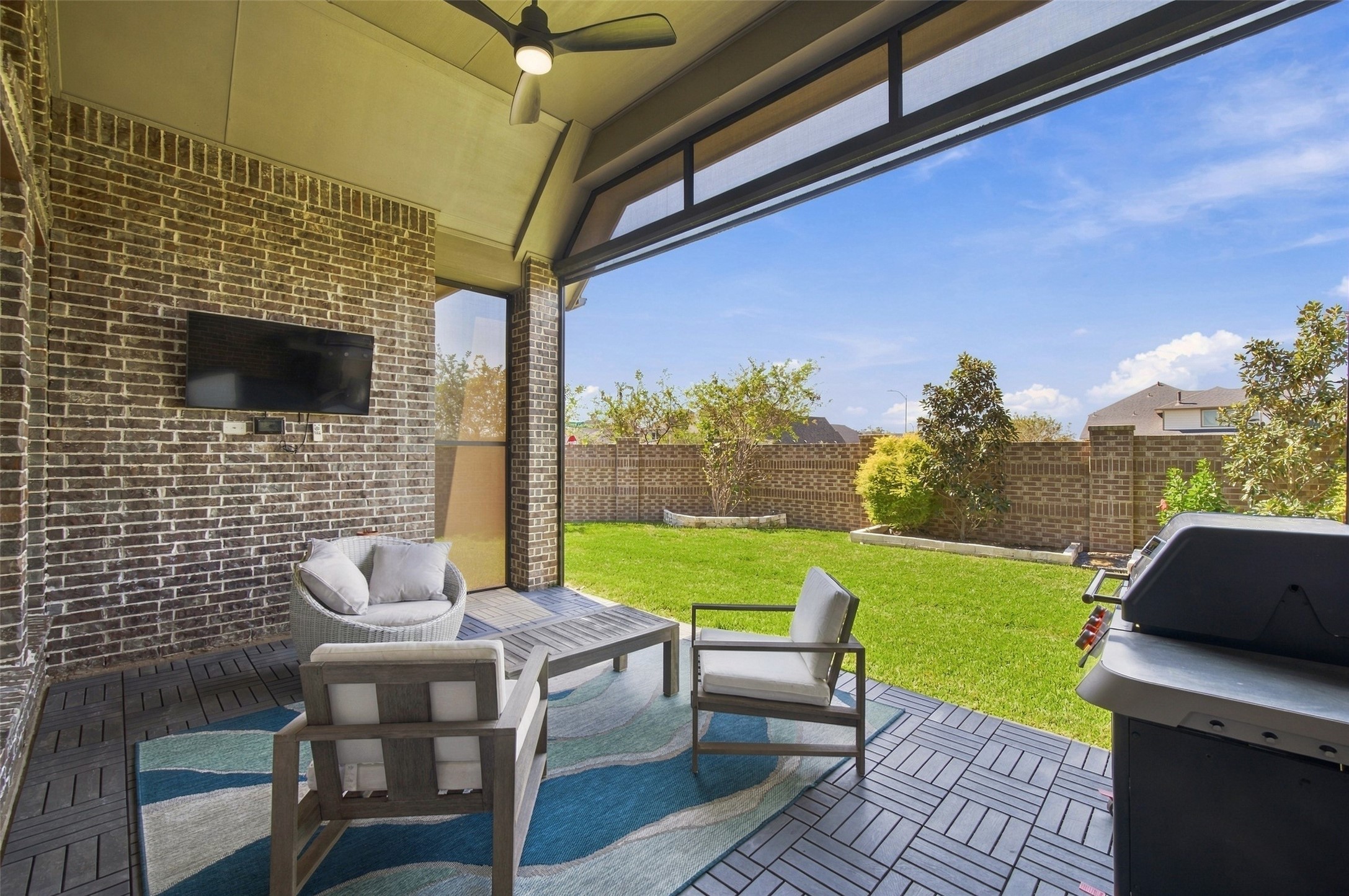 This back patio features remotes controlled sun shades which provide a screened in patio which means you can enjoy this all year round!!