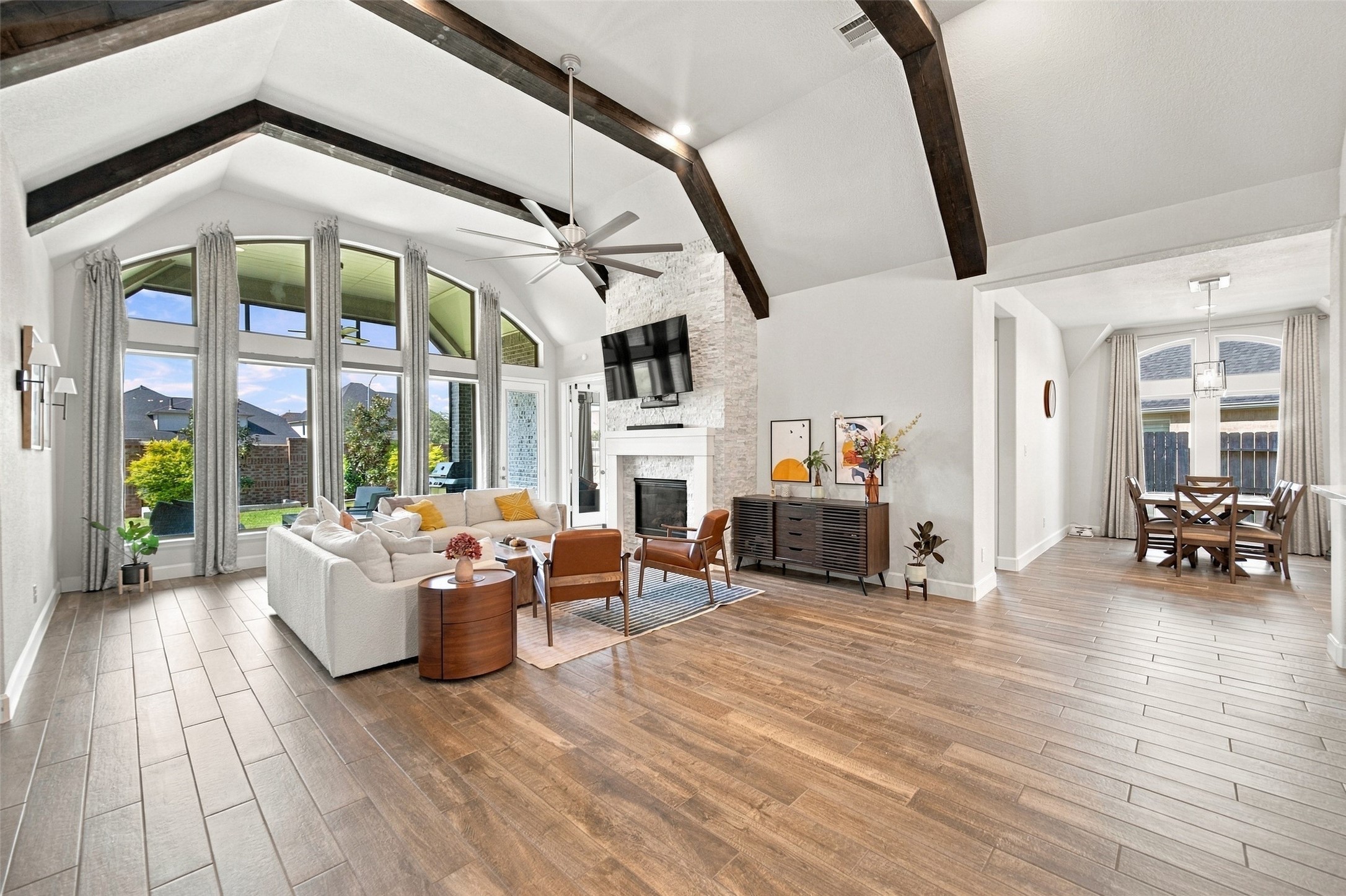 Lots of natural light pour into this room with the beautiful custom beams and stone fireplace! remote control shades complete the windows! Lots of natural light pour into this room with the beautiful custom beams and stone fireplace! remote control shades complete the windows!