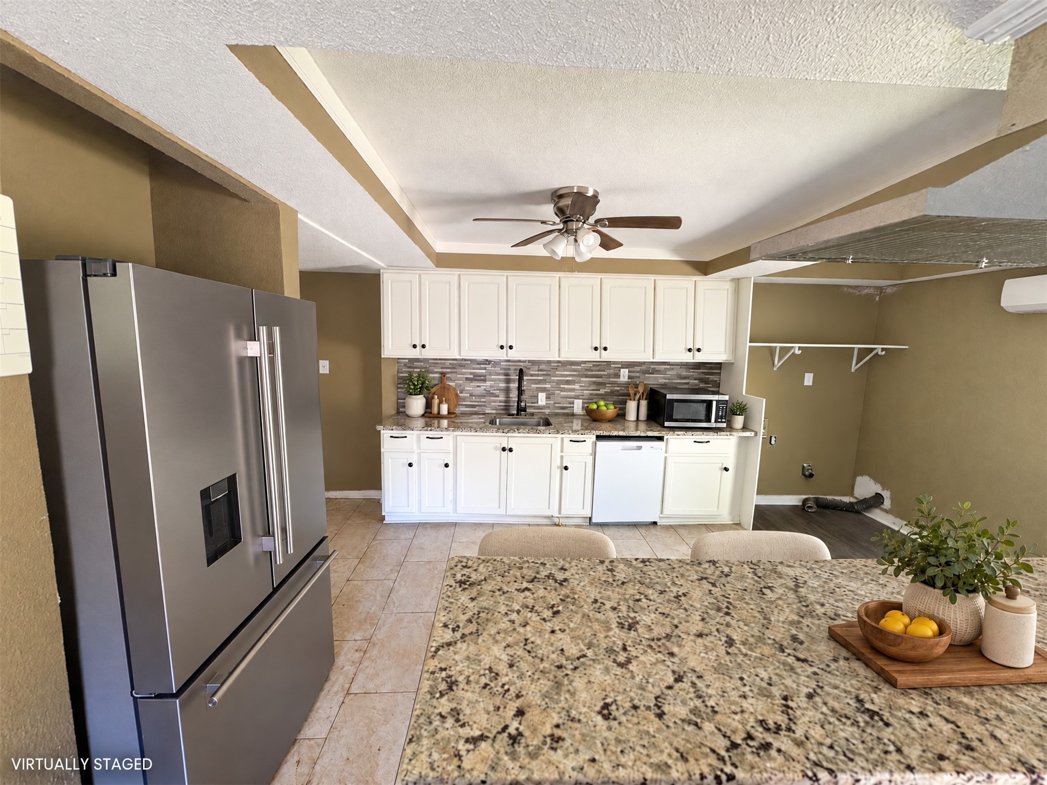 Virtually staged: simple countertop accents and two stools show a possible kitchen setup. Virtually staged: simple countertop accents and two stools show a possible kitchen setup.