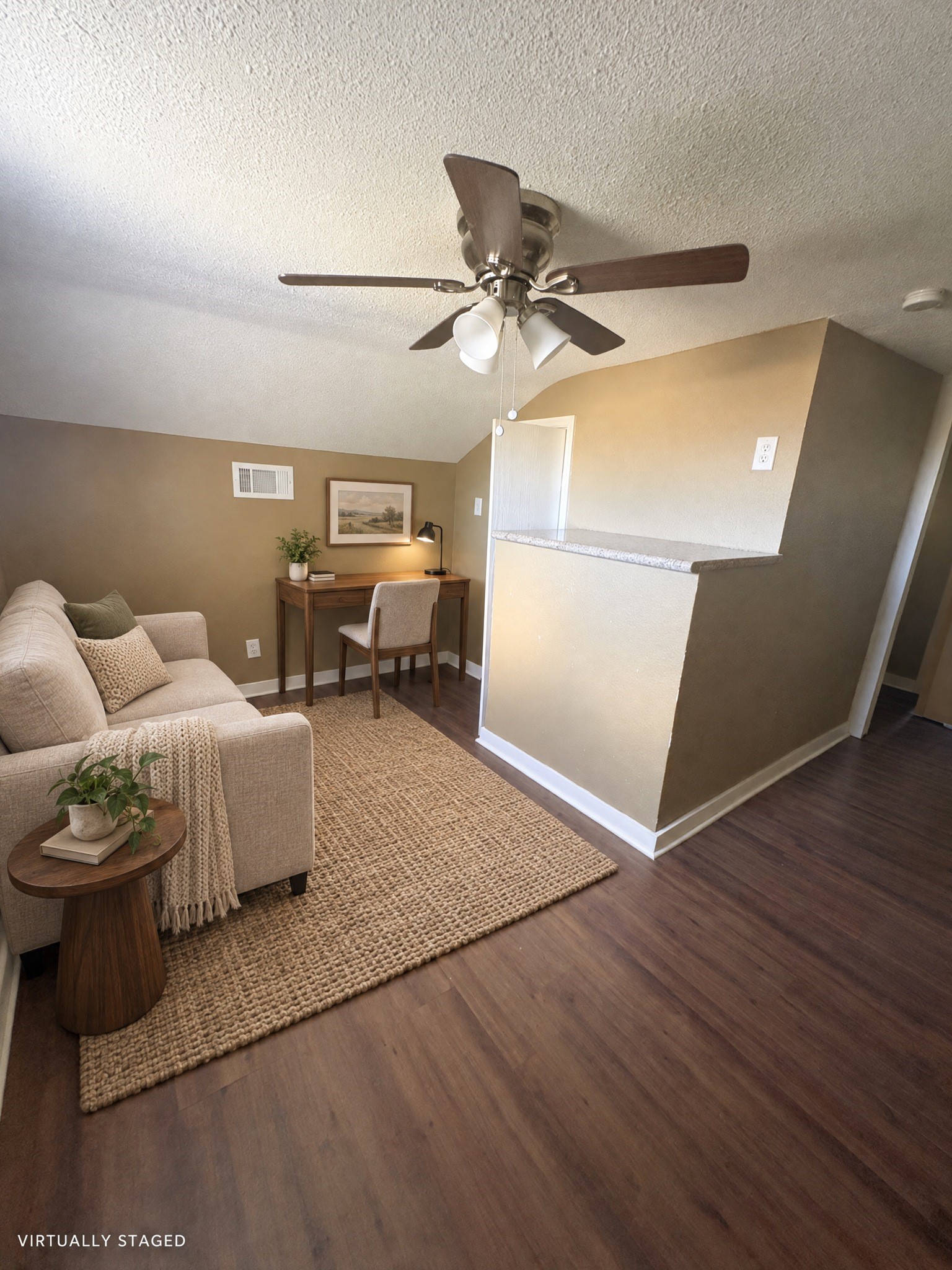 Virtually staged: a compact sitting and work area illustrates one use of the upper-level space.