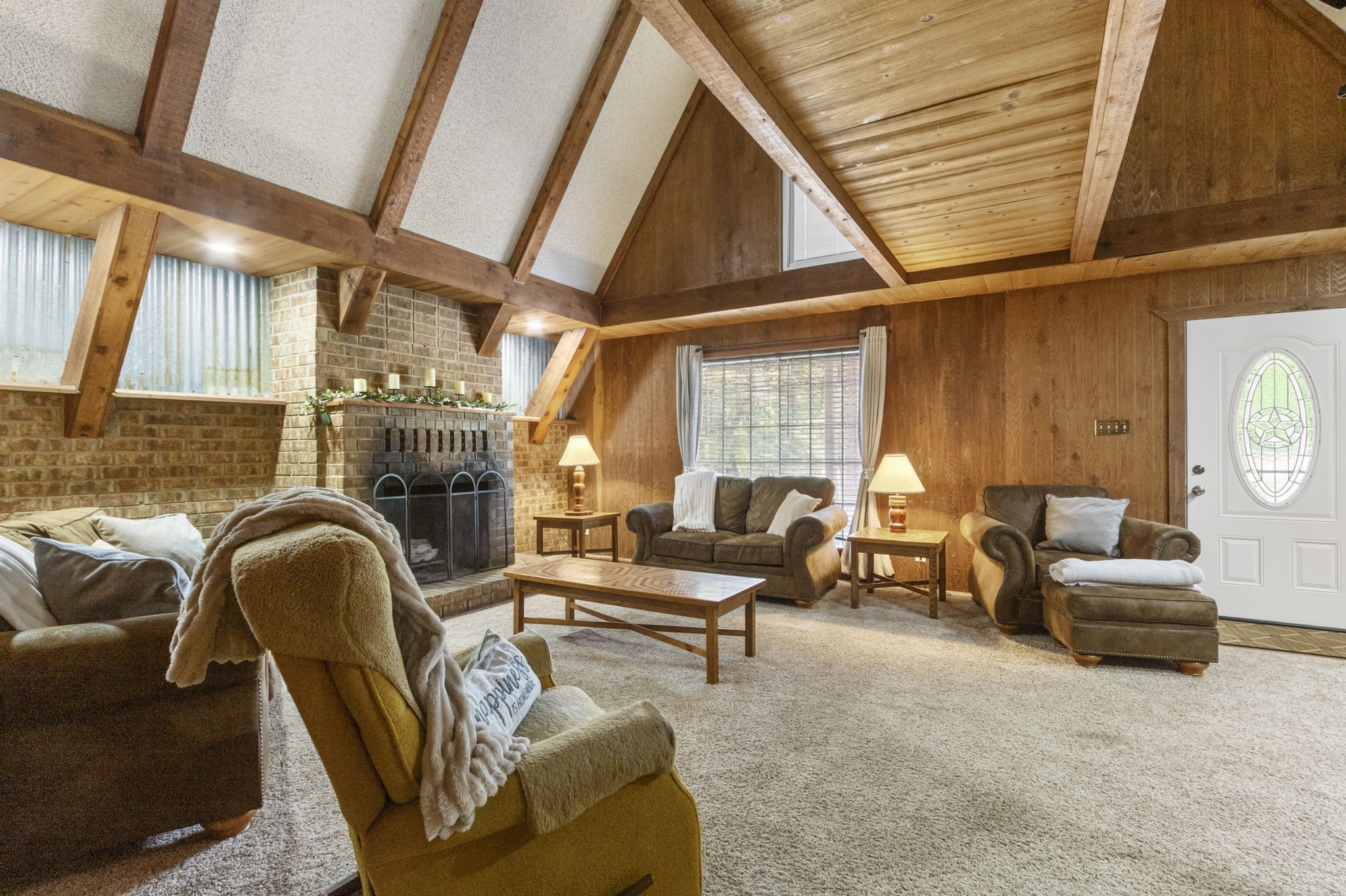 Character, warmth, and room to gather.
The spacious main living area features soaring ceilings and a wood-burning fireplace, creating an inviting place to relax, entertain, and feel right at home.