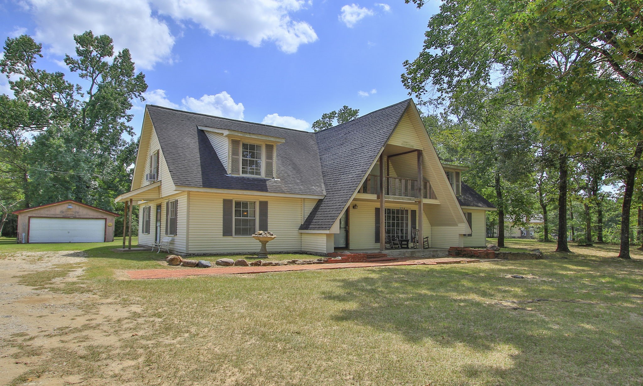 AMAZING 5 ACRE LOT. Main home nestled in a wooded setting, featuring a spacious front porch, front balcony, shop, space for animals, and a detached two-car garage. AMAZING 5 ACRE LOT. Main home nestled in a wooded setting, featuring a spacious front porch, front balcony, shop, space for animals, and a detached two-car garage.