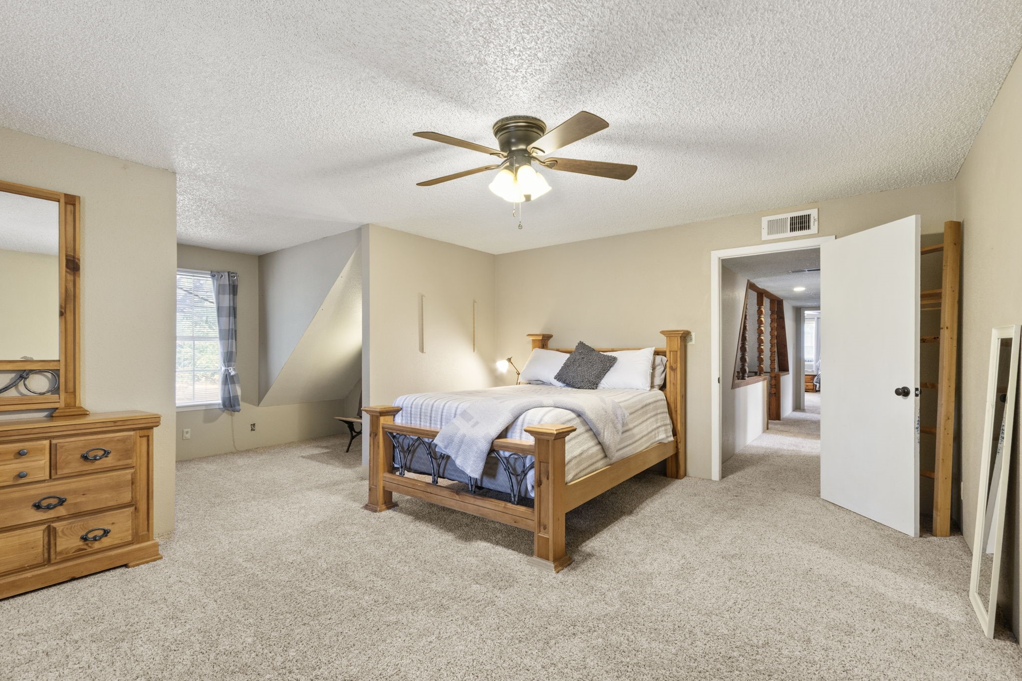 The split-bedroom layout offers two generously sized bedrooms upstairs and two bedrooms downstairs, providing plenty of space and flexibility throughout the main home