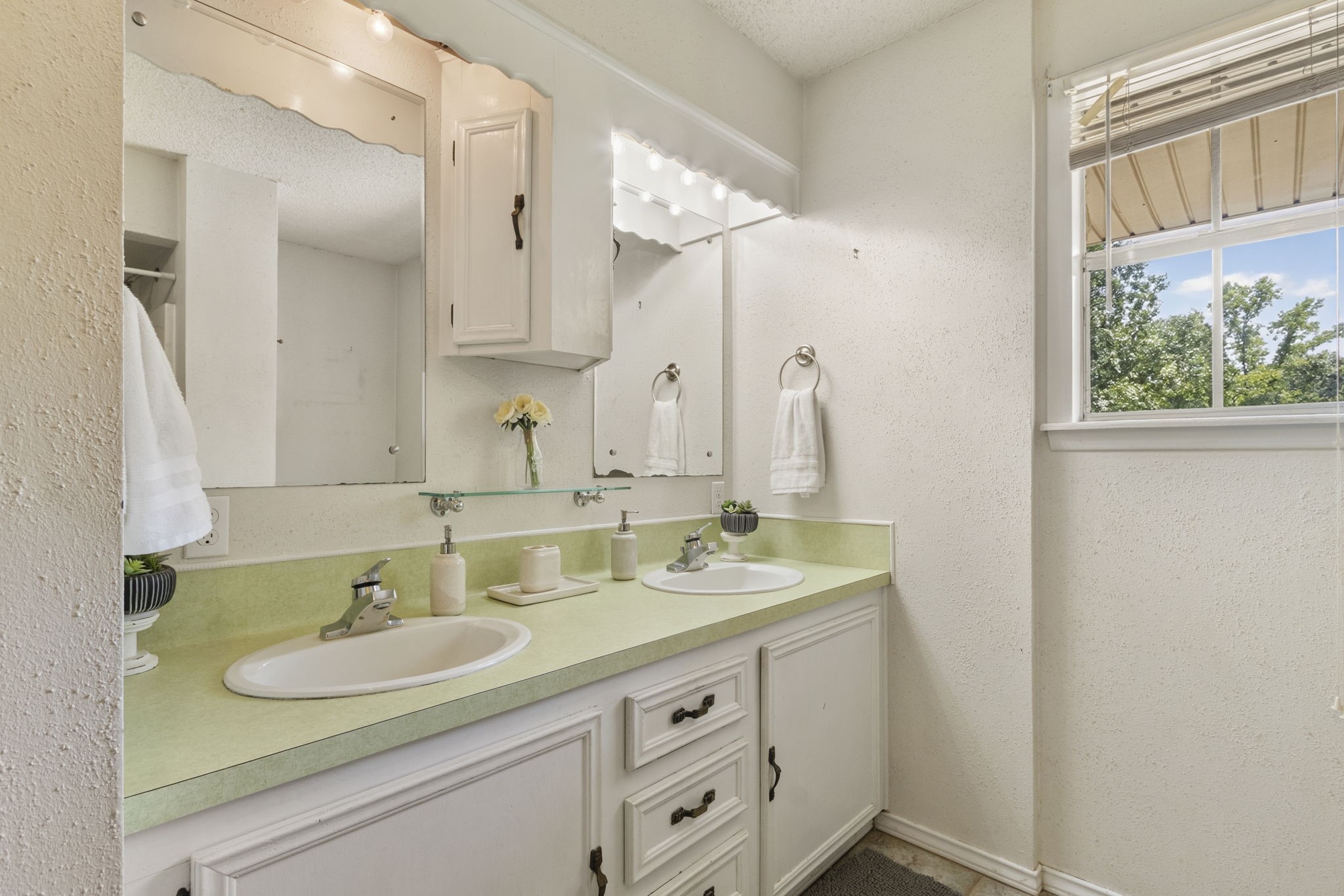 The upstairs full bathroom features dual sinks and a convenient shower and tub combination.