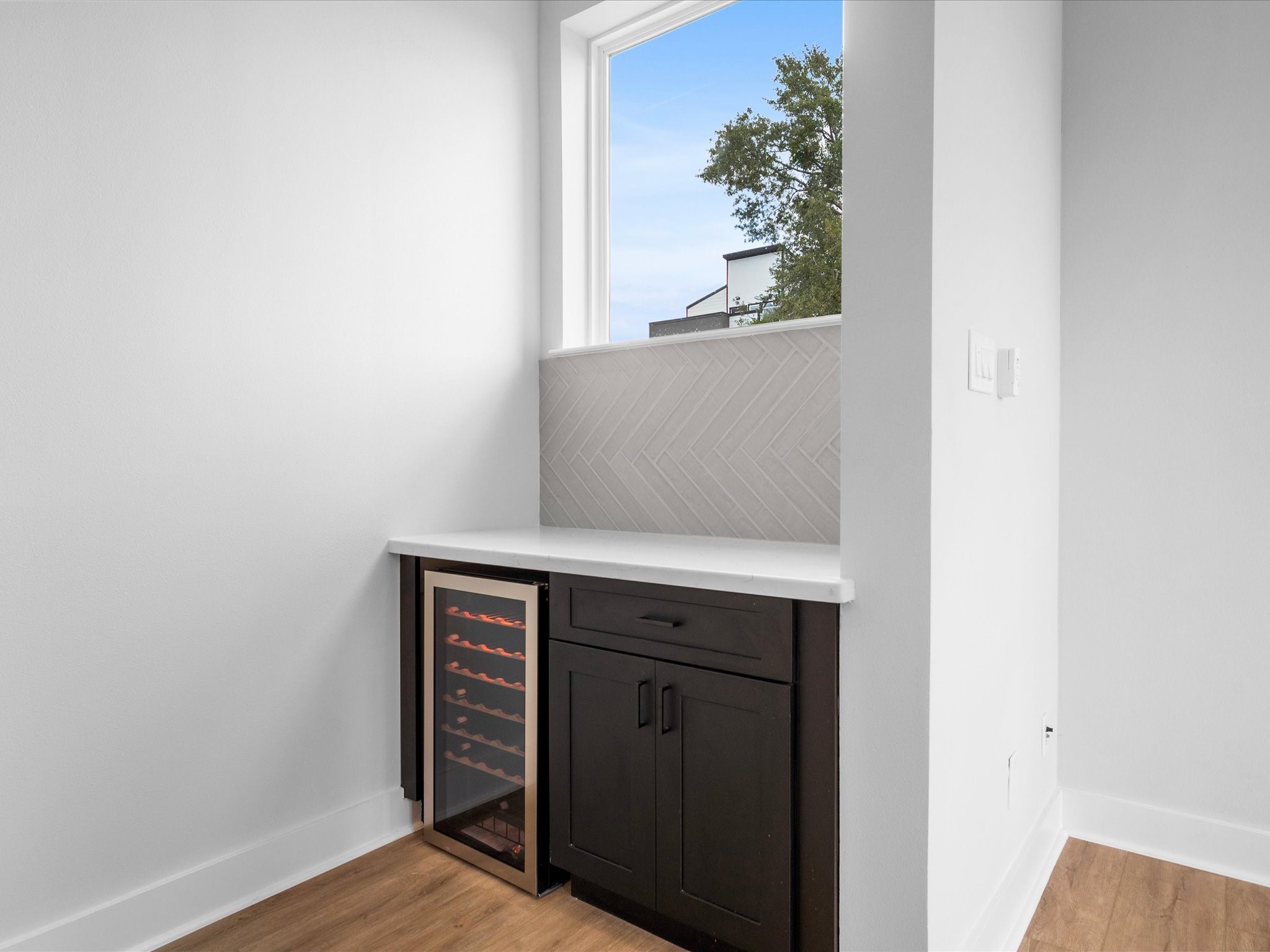 A stylish dry bar with a beverage fridge creates the perfect spot for entertaining.