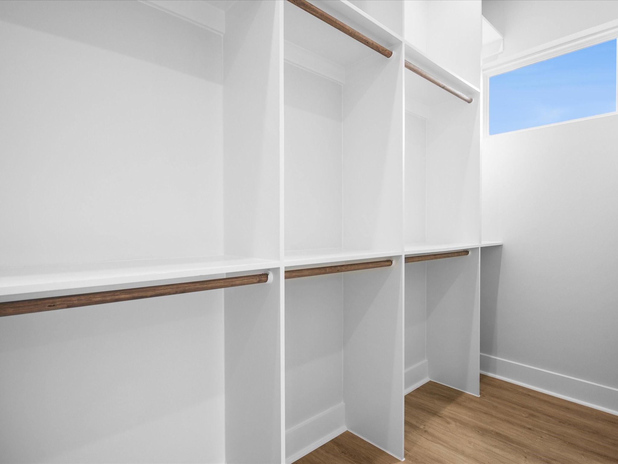 The spacious primary closet features built-in storage to keep wardrobes and accessories organized.