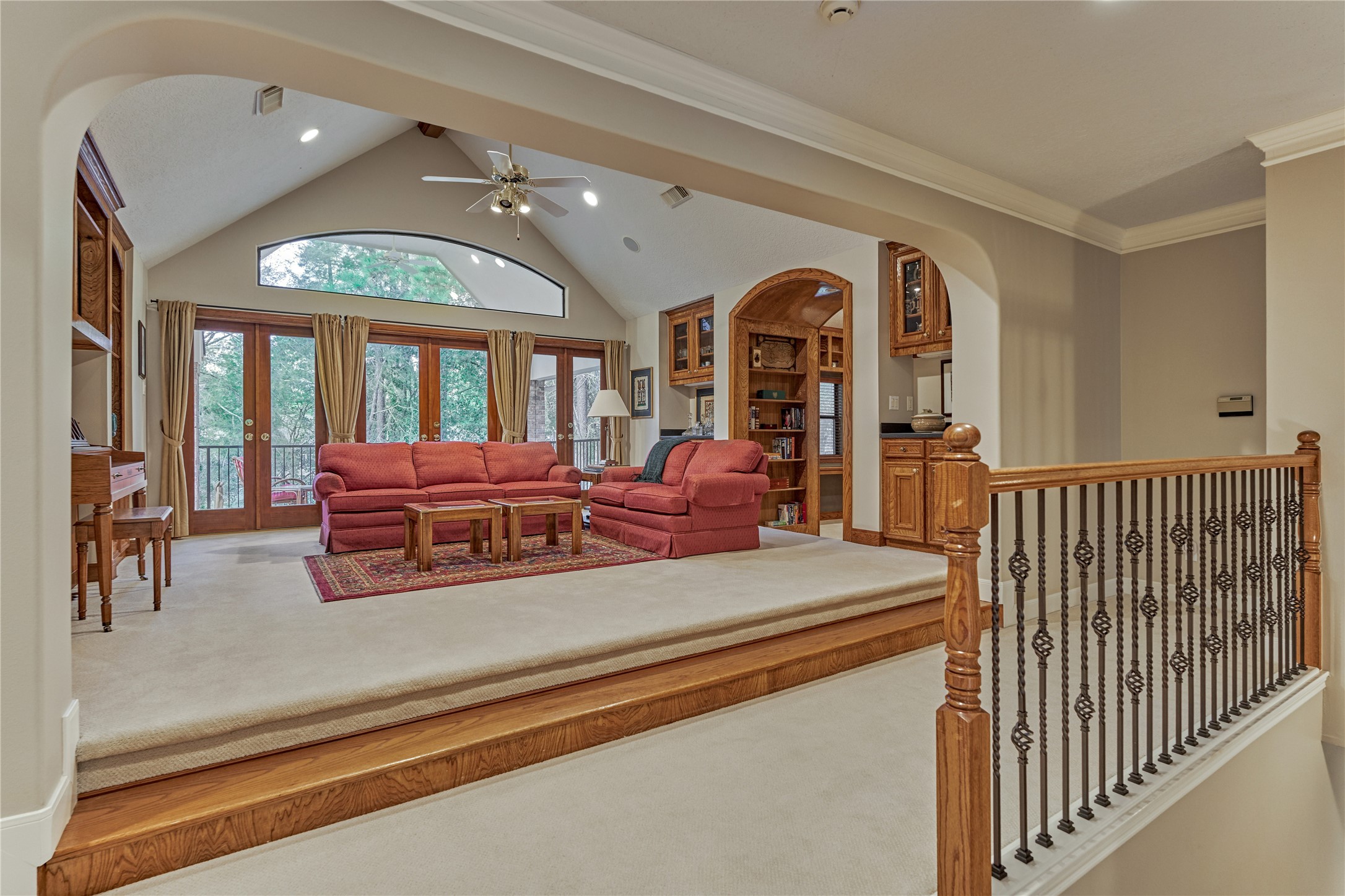 The game room overlooks the grand foyer and features custom built-in storage.