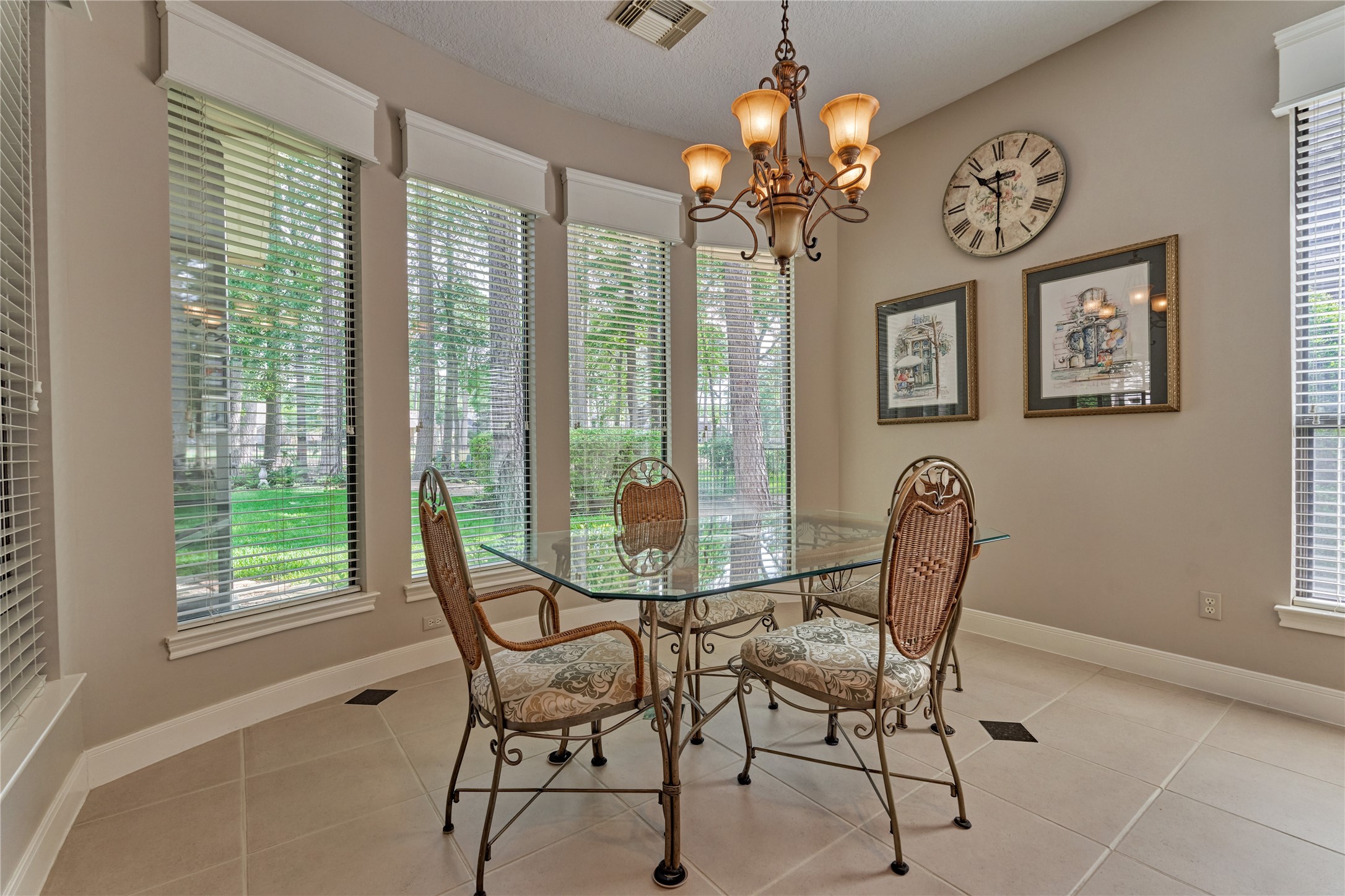 The breakfast room is awash in natural light, which streams in through large picture windows.