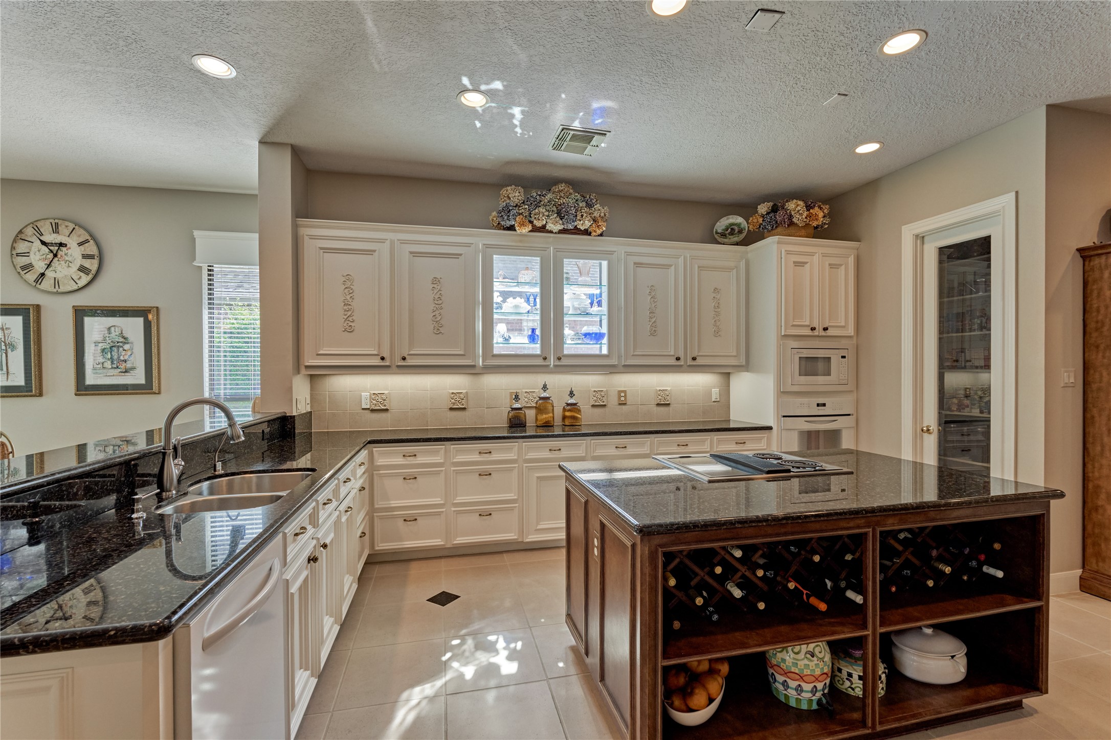 Gleaming granite countertops provide a nice contrast to the crisp white cabinetry.