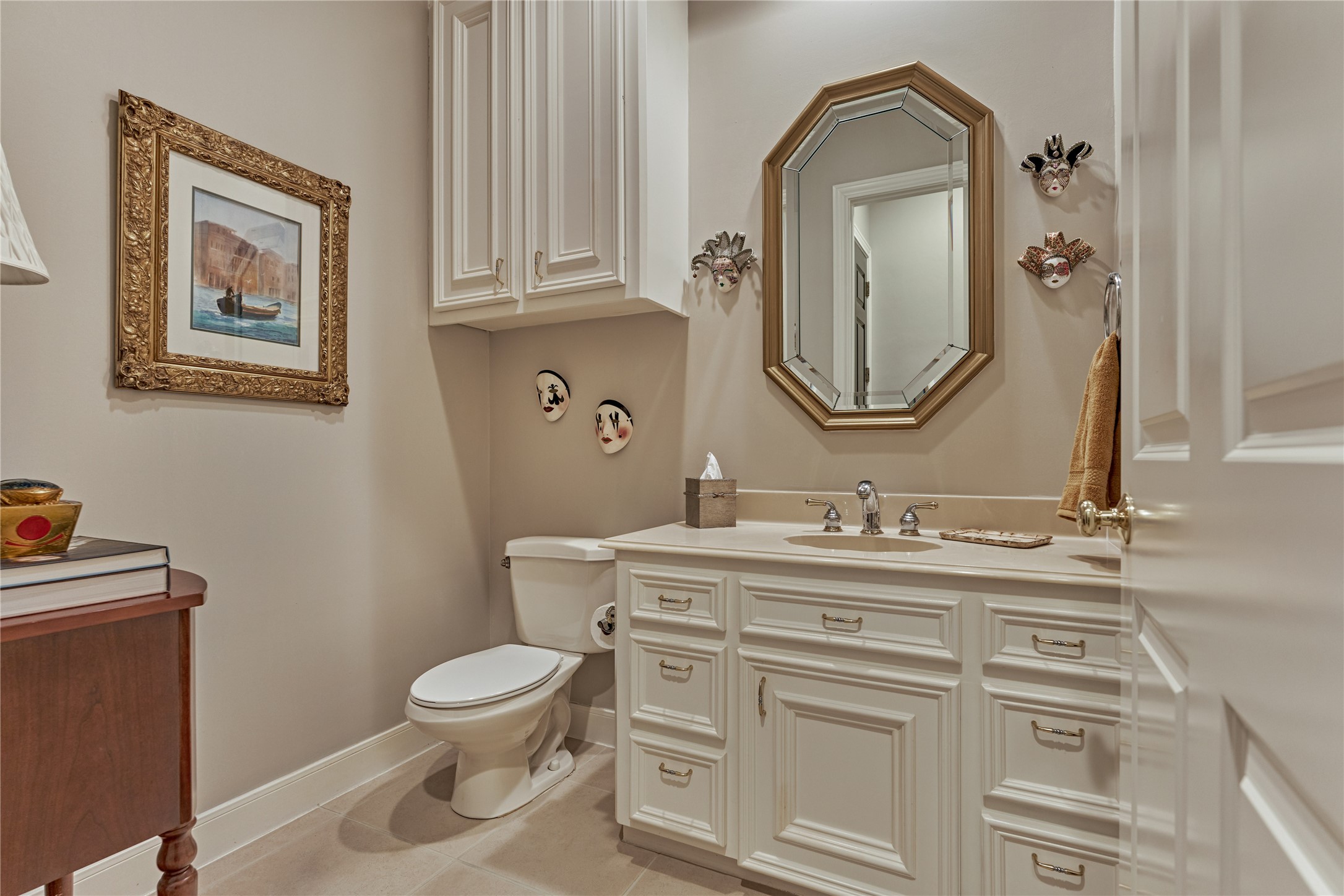Powder room just off the kitchen and laundry room area.