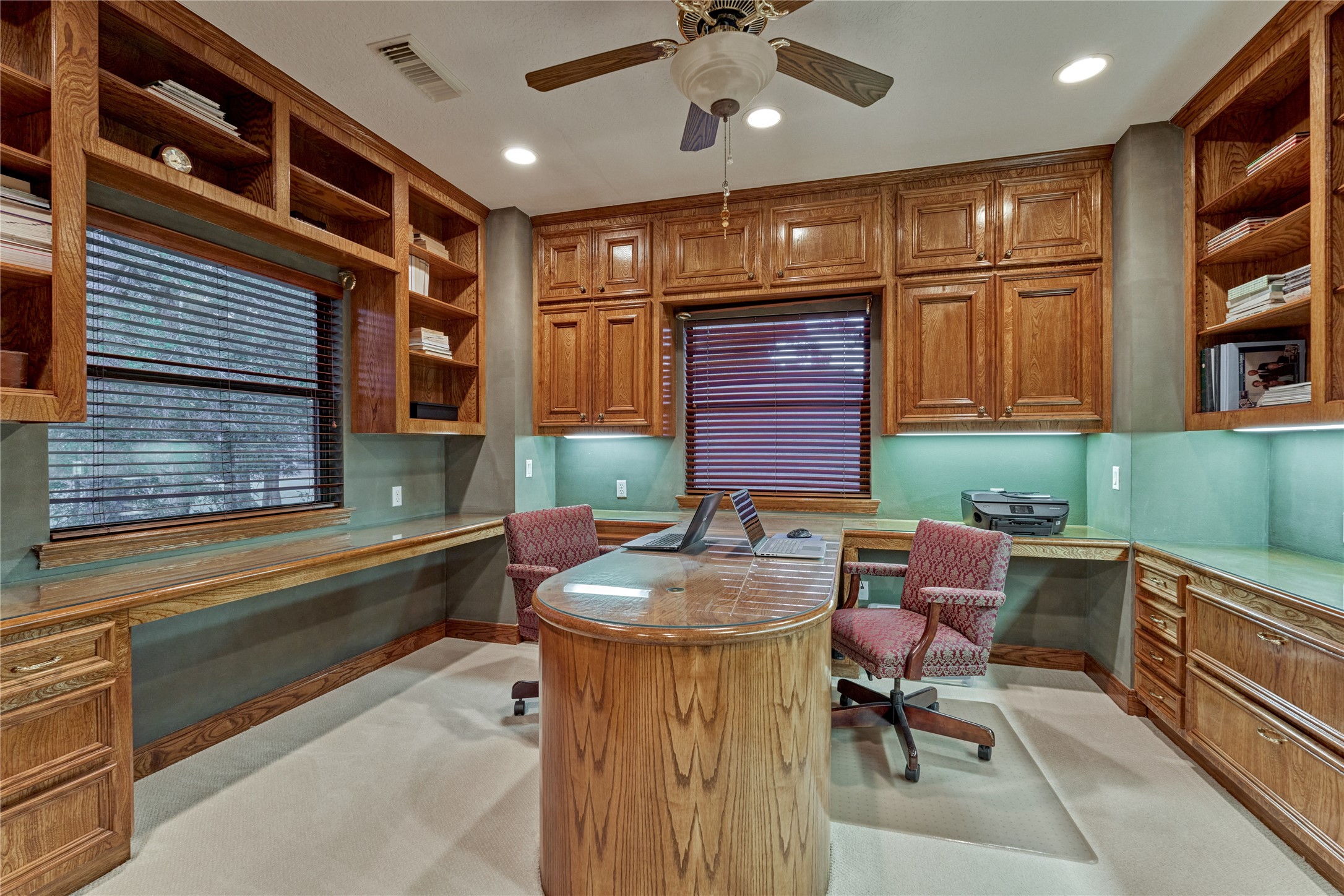 Rich wood cabinetry provides abundant storage in the handsome study.