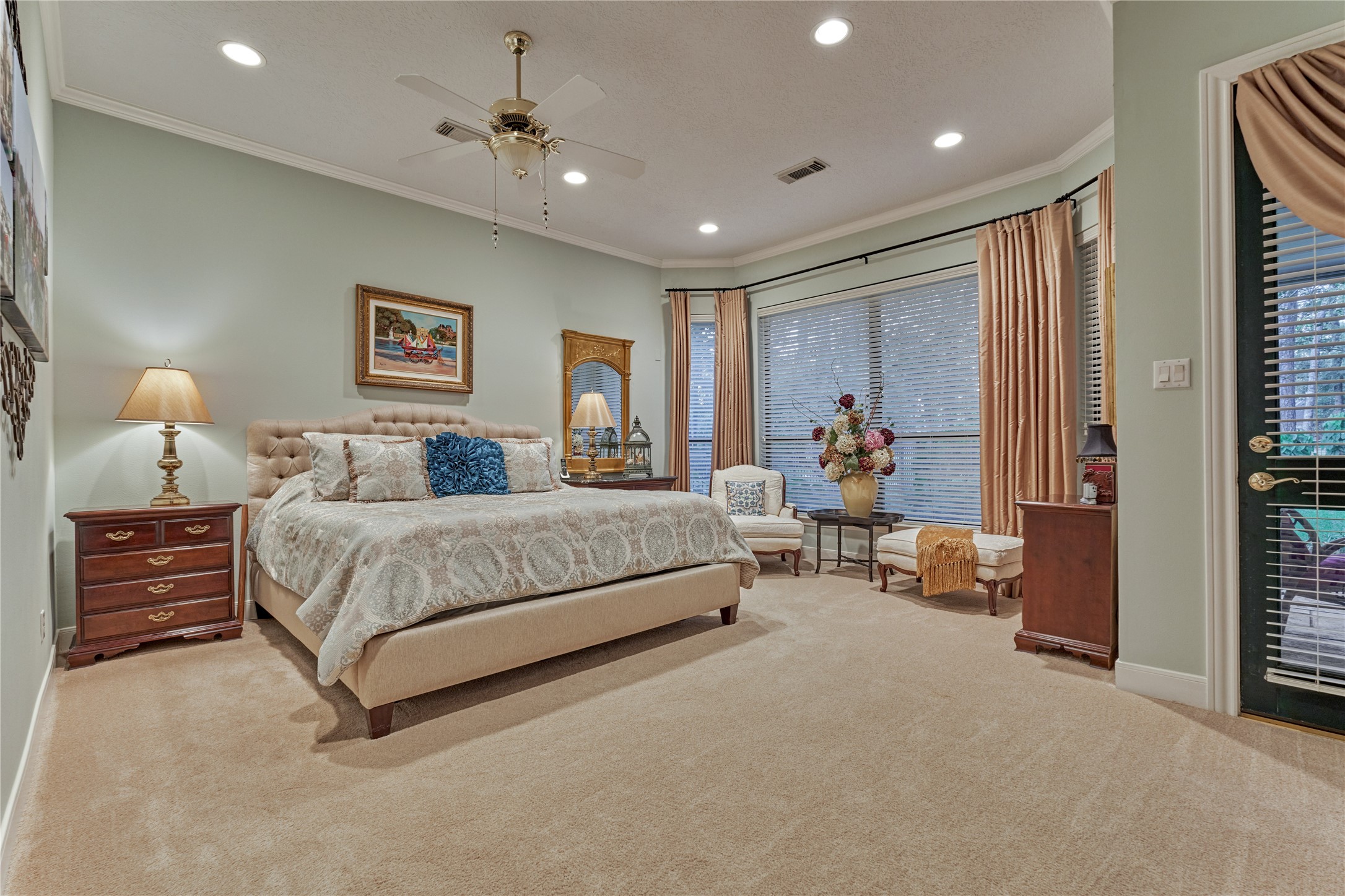 The primary retreat has a spacious sitting area with huge light filled windows to enjoy backyard views and access to back patio and yard.