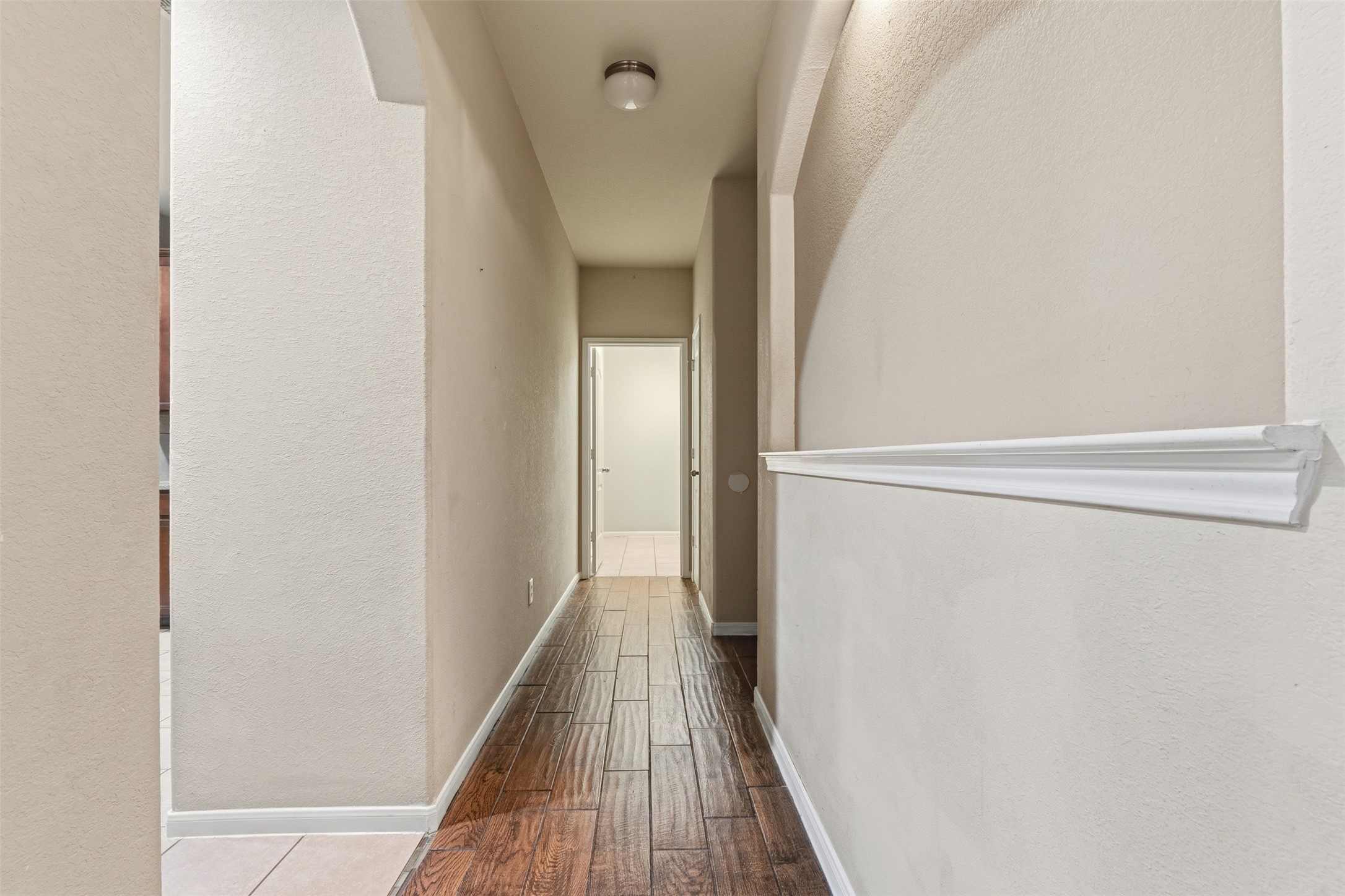 Hallway to the garage, half bath and laundry