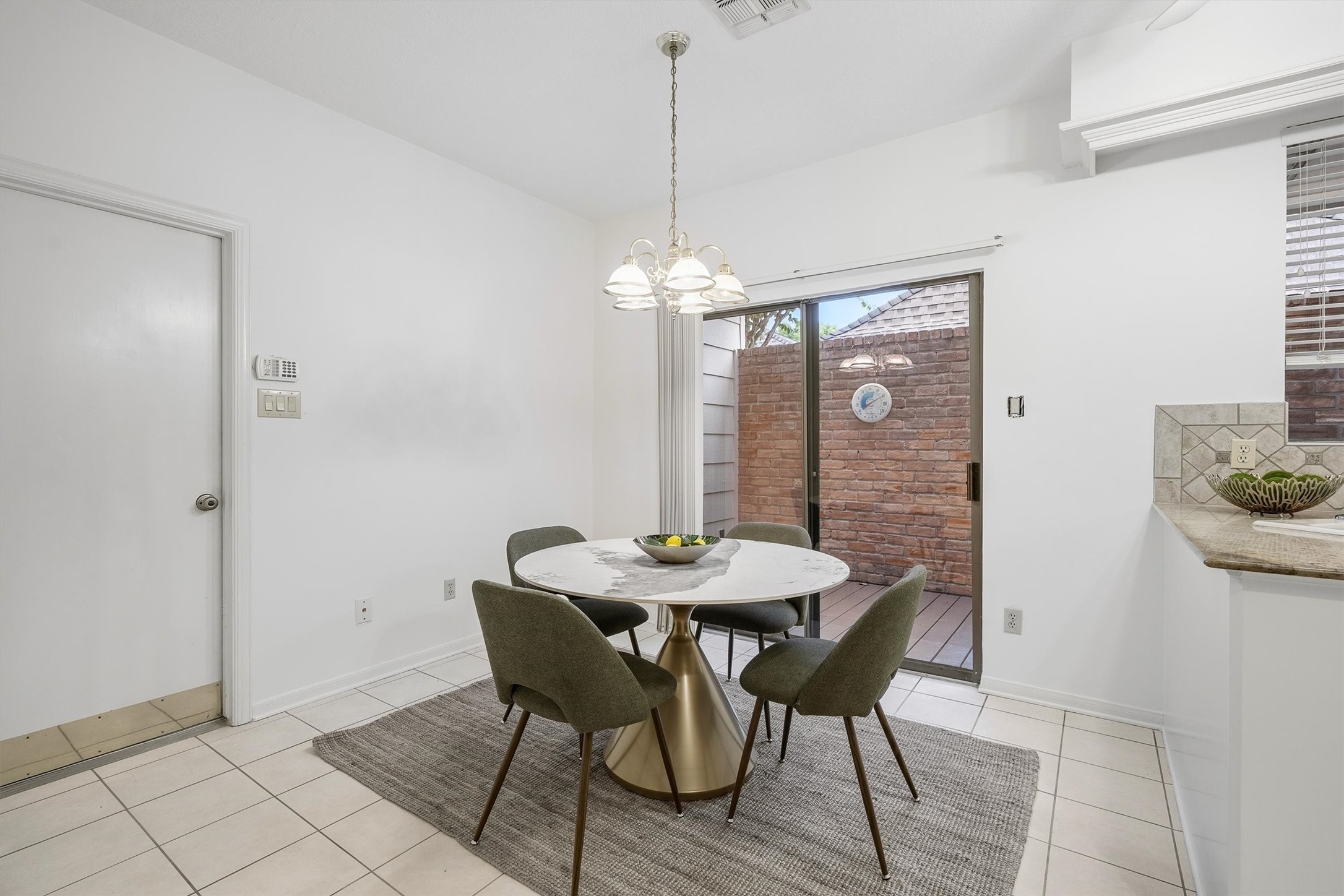 Bright dining area featuring a sliding glass door leading to a private patio.